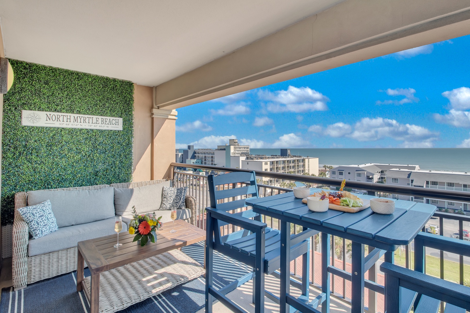 Savor your morning coffee on this stylish balcony with stunning ocean views and comfortable seating.