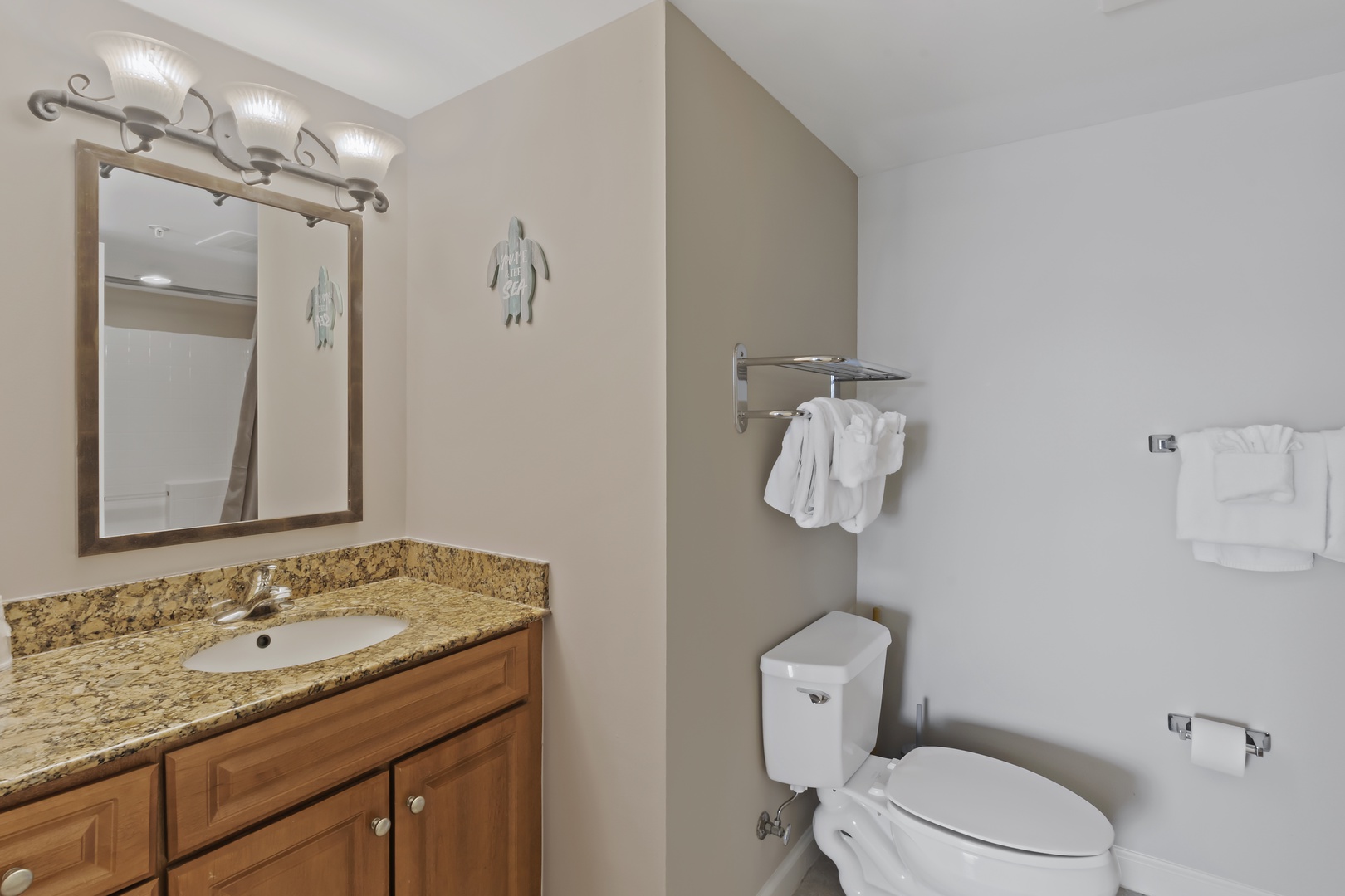Freshen up in your private bathroom with granite countertop, rich wood vanity, and plush towels ready for your stay.