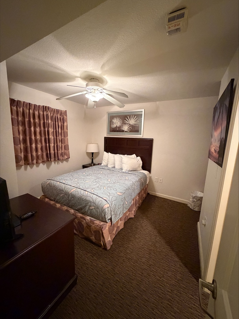 Step into your cozy bedroom retreat with soft lighting, plush bedding, and a ceiling fan to keep you comfortable. The warm wood tones and inviting décor create the perfect space to unwind after a day of adventure.