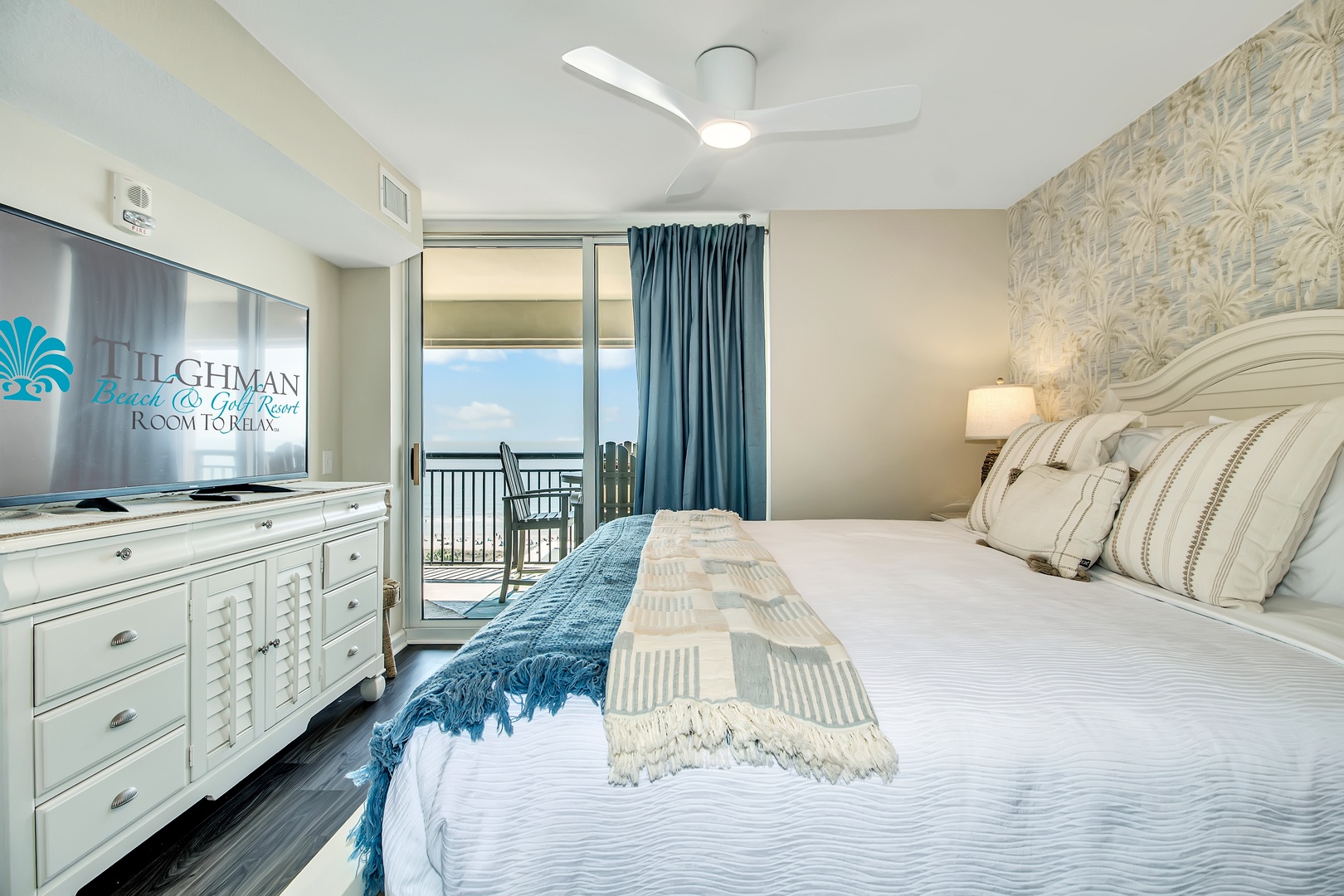 Wake up to stunning ocean views from your beautifully appointed bedroom with coastal décor and private balcony access.