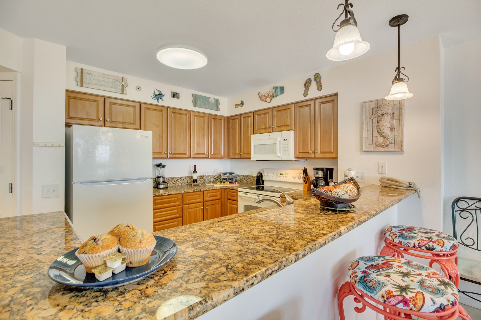Your fully equipped kitchen features granite countertops, warm wood cabinets, and everything you need to create memorable meals during your stay.