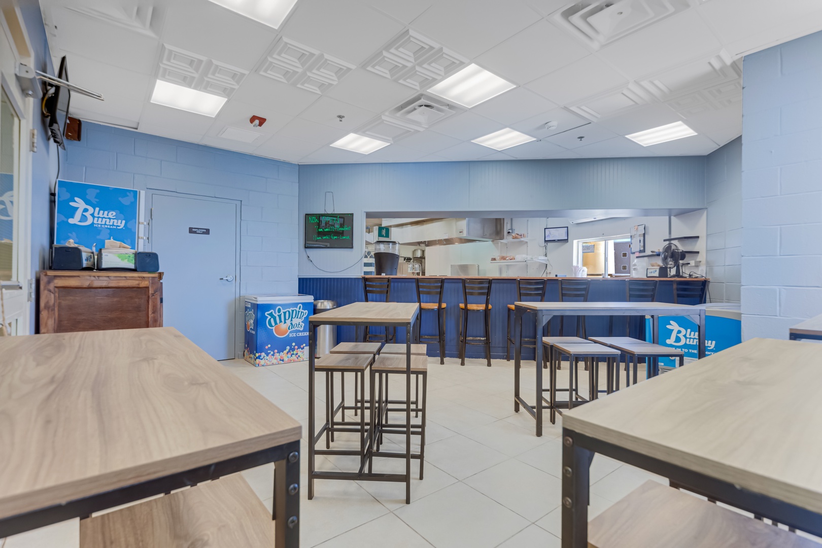 Spacious communal dining area with a fully equipped kitchen, perfect for preparing and sharing meals with fellow travelers in a bright, welcoming space.