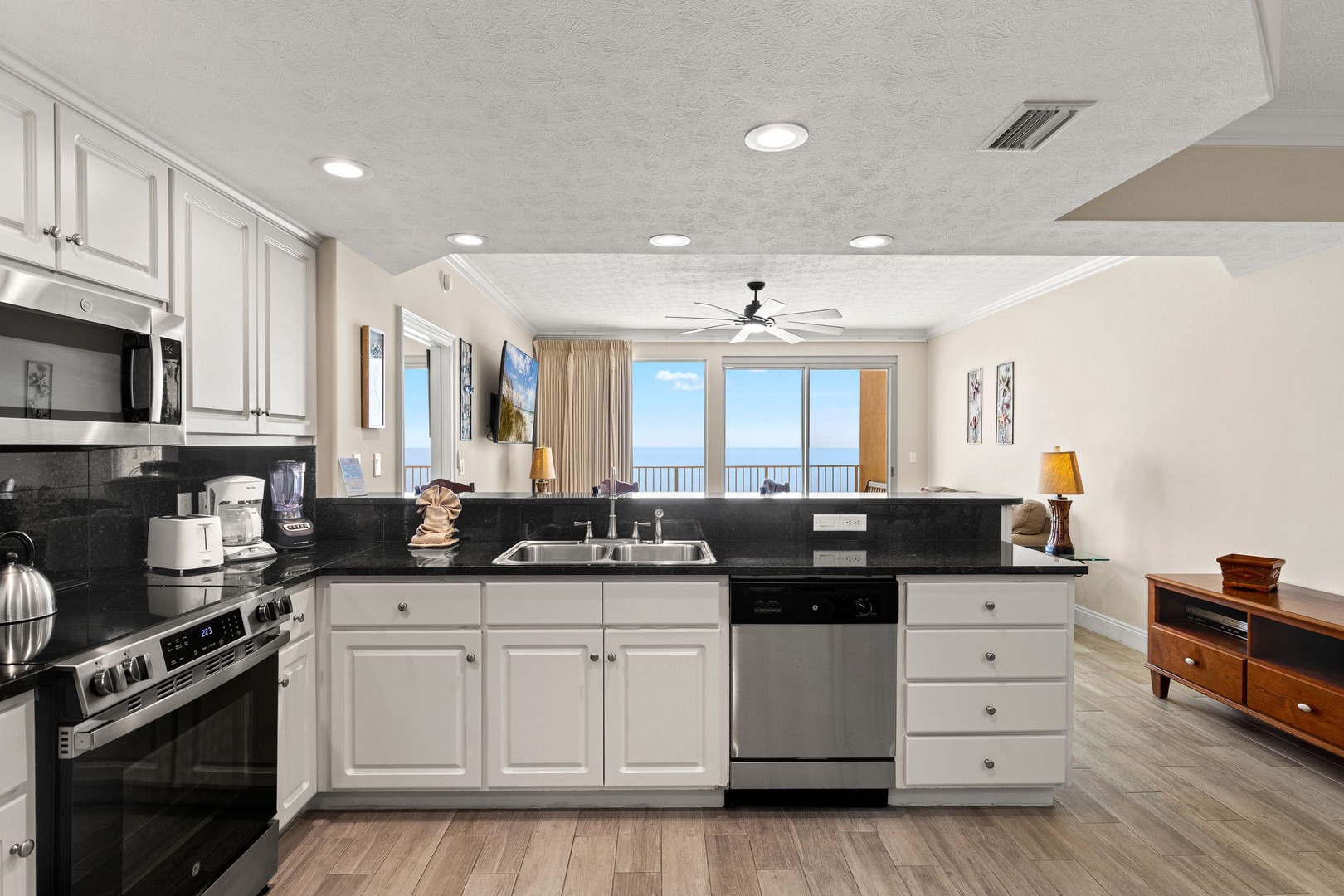 Your fully-equipped kitchen invites you to prepare meals while enjoying stunning ocean views through expansive windows.