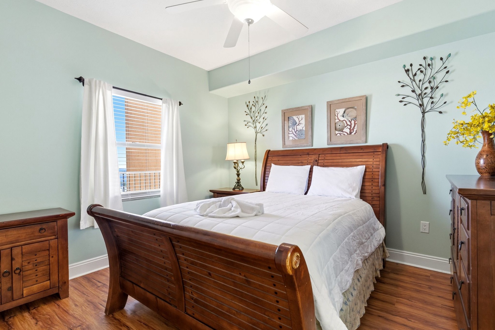 Drift off to sleep in your serene bedroom, where soothing mint walls and rich wood furnishings create the perfect retreat.
