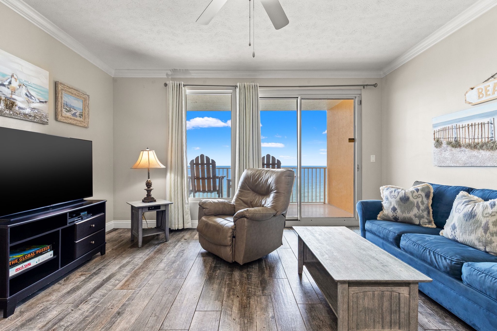 Unwind in your inviting living room with plush seating and sweeping ocean views just beyond your private balcony, where coastal breezes and endless blue skies set the scene for total relaxation.