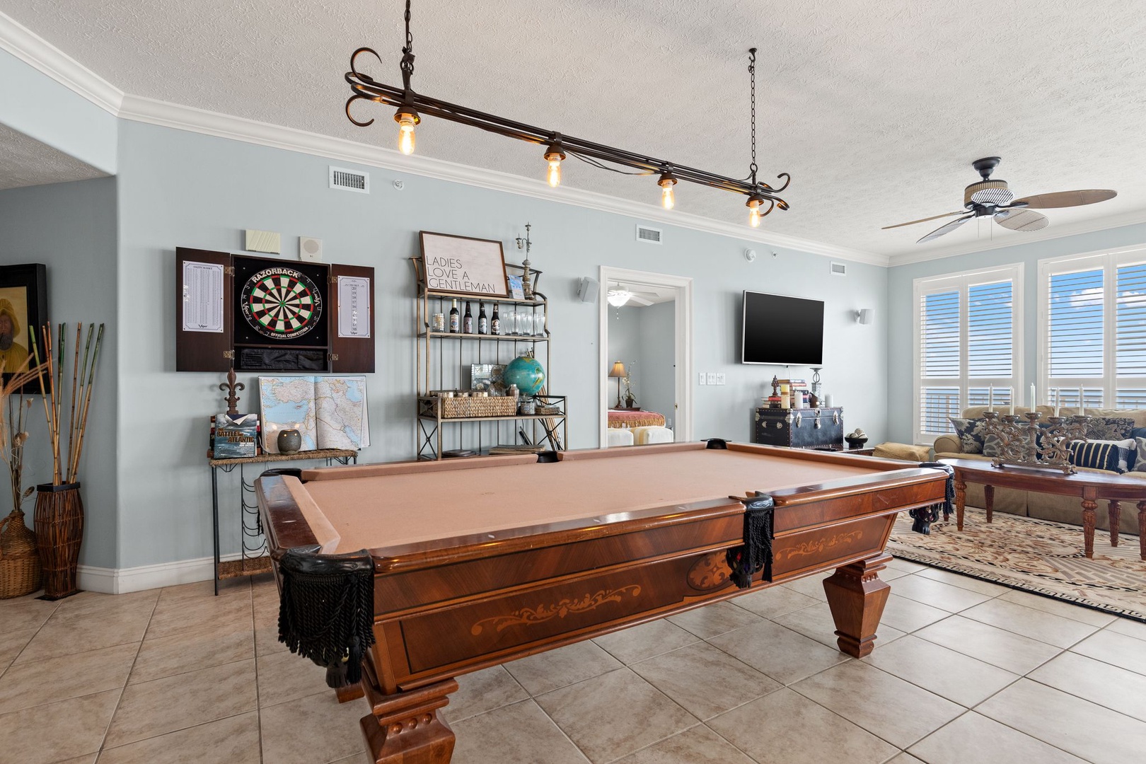 Challenge your friends to a game on this beautiful billiard table, set in a bright, open space with coastal-inspired decor and a dartboard for extra fun.