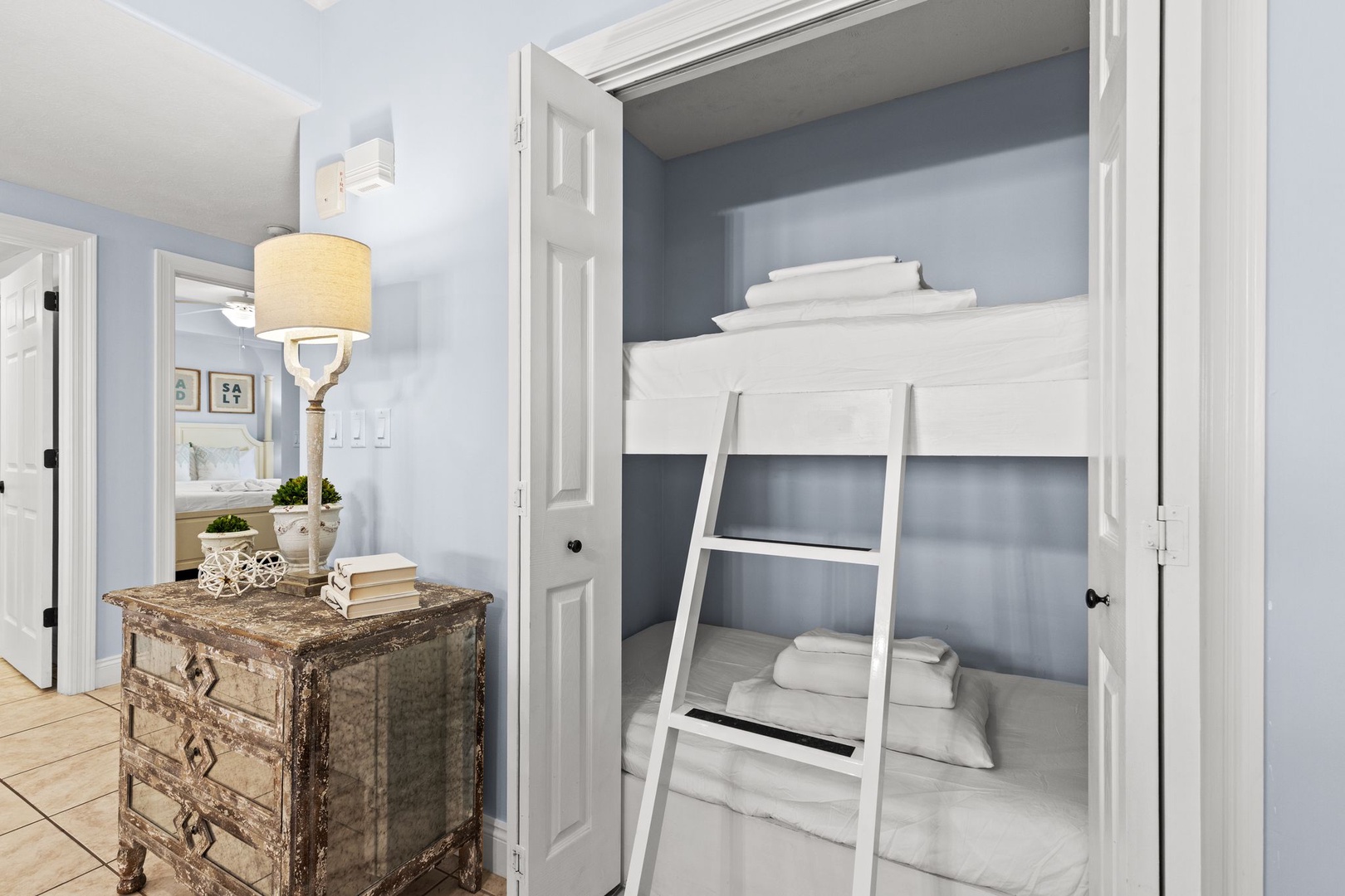 Your cozy bunk alcove features crisp linens and a sleek ladder, perfect for families or friends traveling together in coastal comfort.