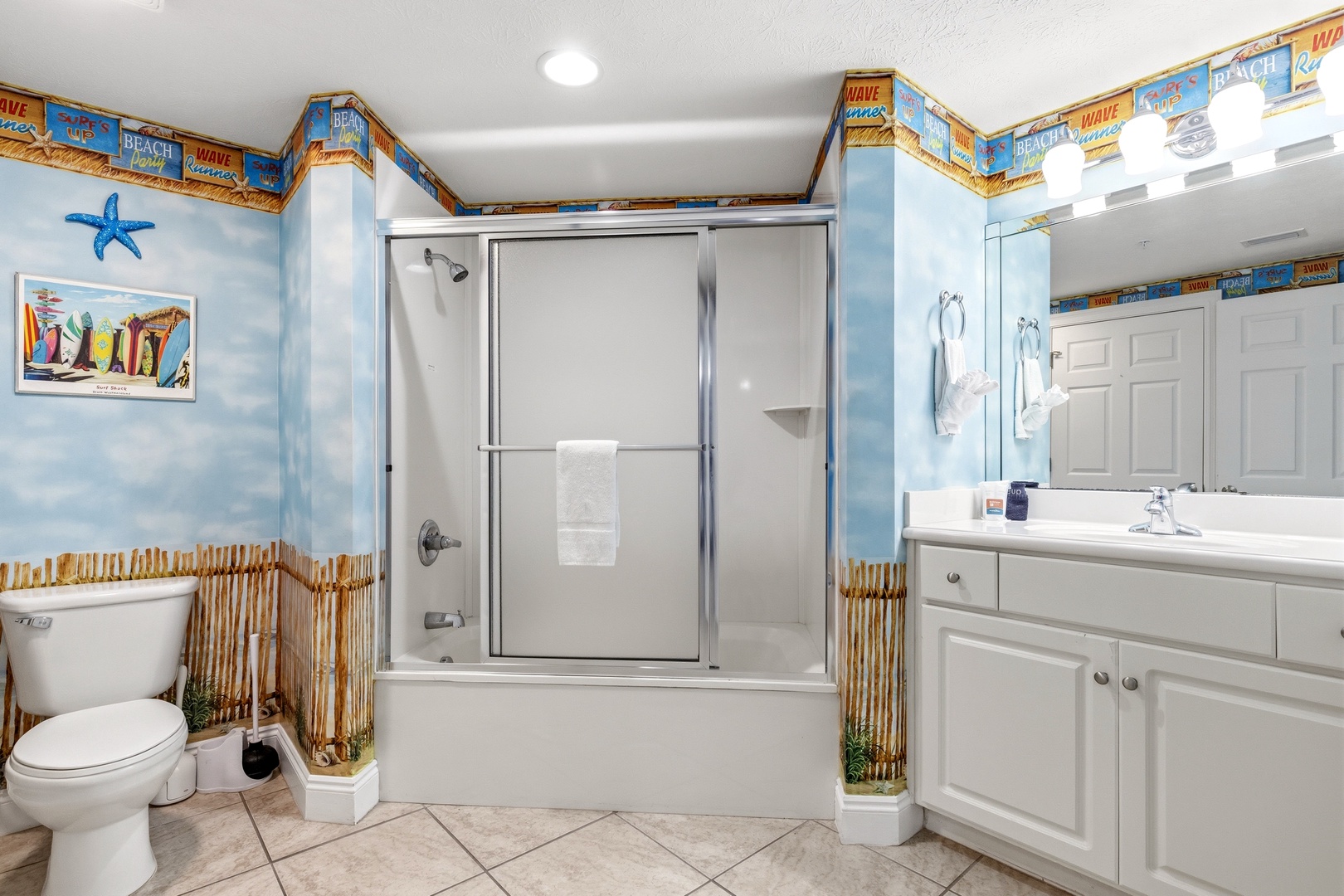 Step into your cheerful beach-themed bathroom where ocean blues and bamboo accents create a tropical escape for your daily routine.