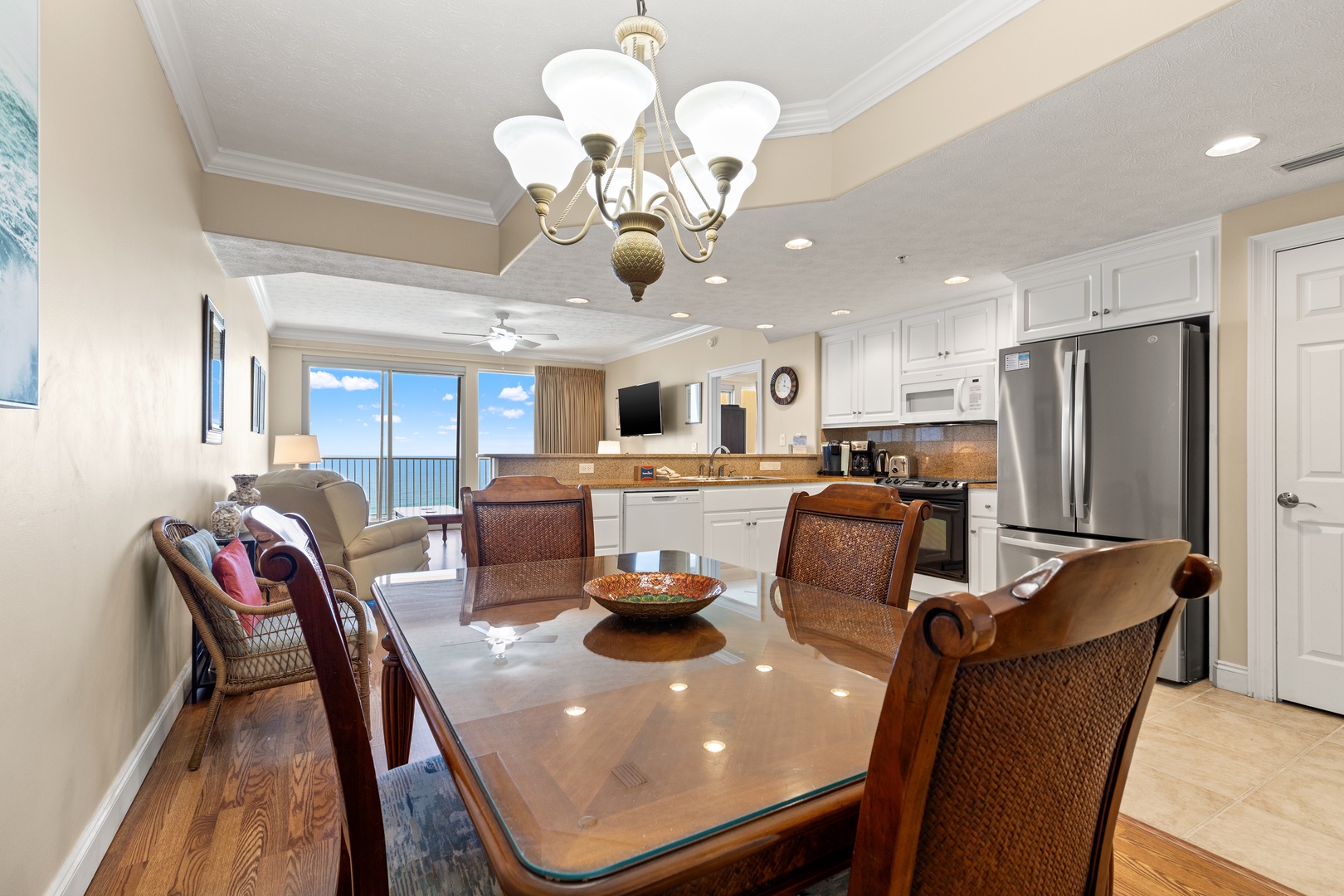 Gather around this elegant dining table with ocean views stretching beyond, then step into your fully equipped kitchen where every detail awaits your culinary adventures.
