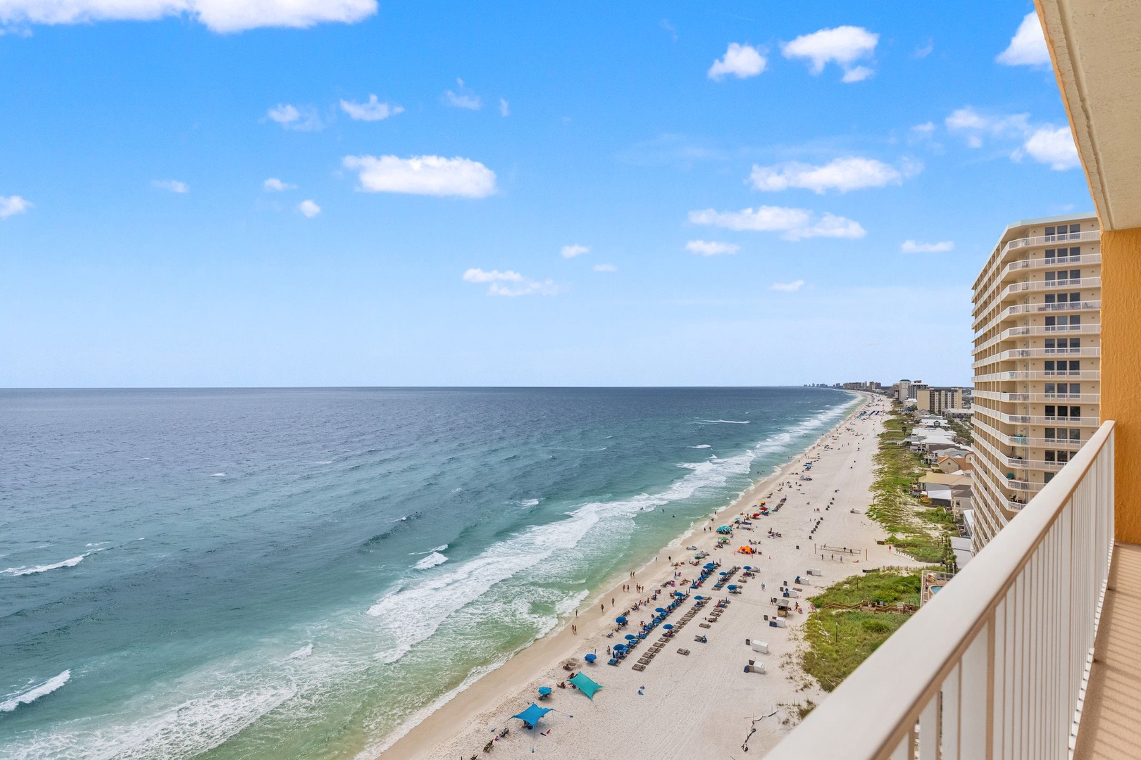 Stunning beachfront views stretch from this elevated balcony, showcasing pristine coastline, gentle waves, and expansive ocean horizons—part of the vibrant coastal neighborhood surrounding this property.