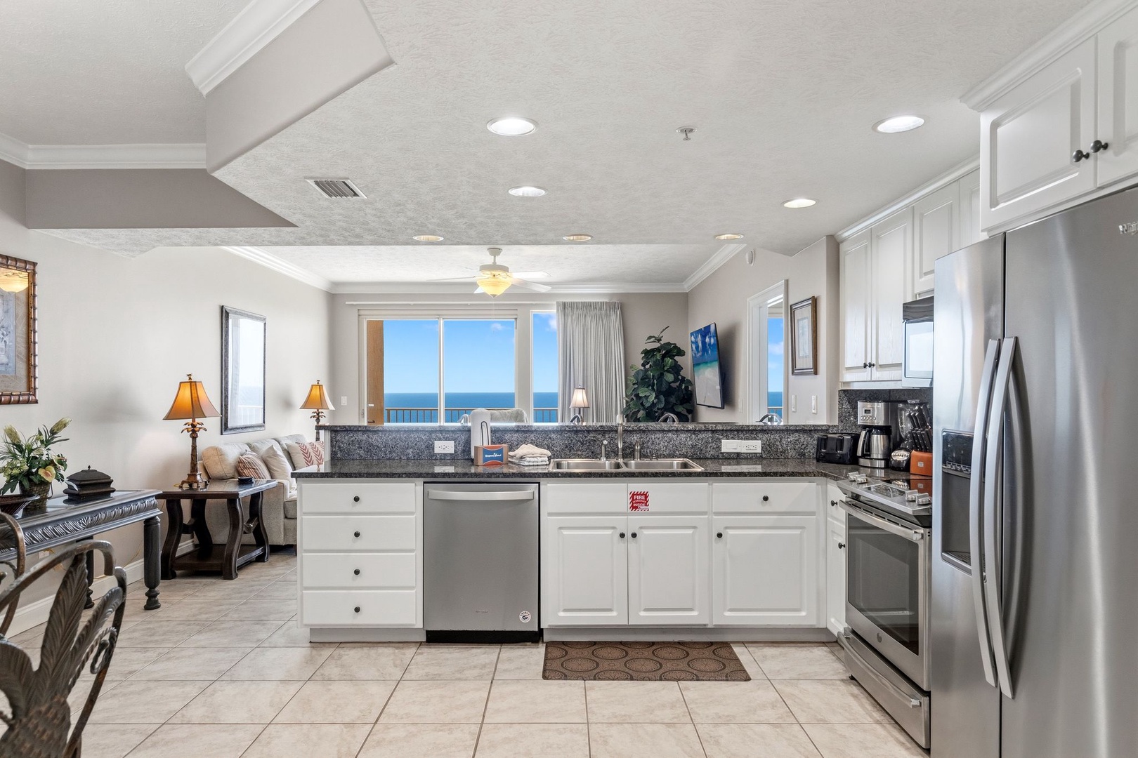 Cook with stunning ocean views streaming through your windows in this fully equipped kitchen with granite counters and stainless steel appliances.