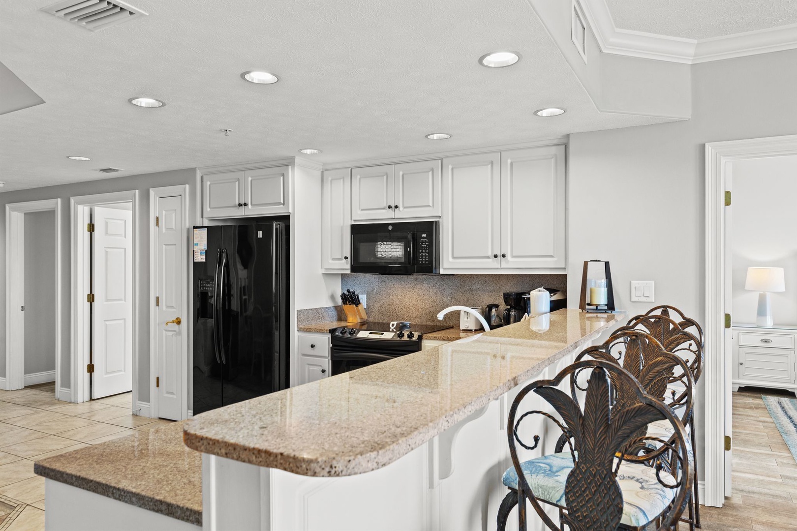 Your fully equipped kitchen features granite countertops, modern appliances, and plenty of space to prepare meals during your stay.