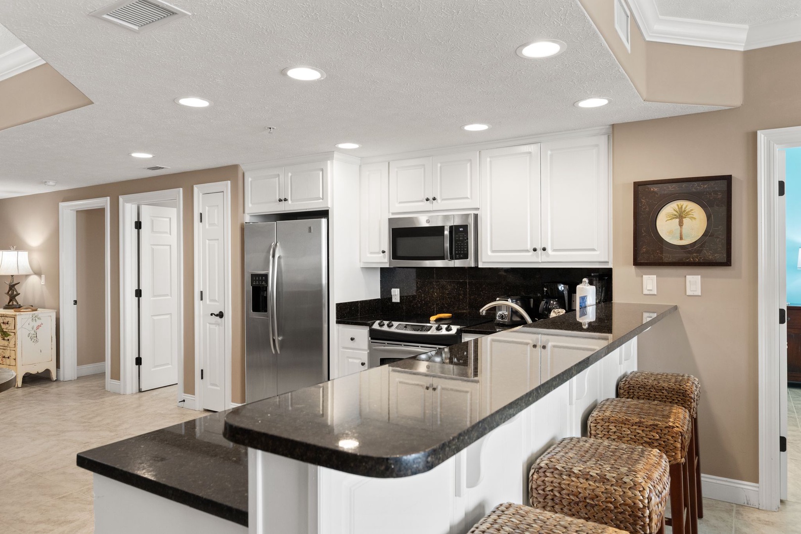 Step into a chef-ready kitchen where gleaming granite countertops and modern appliances invite you to whip up vacation feasts. Gather at the breakfast bar and plan your day ahead.