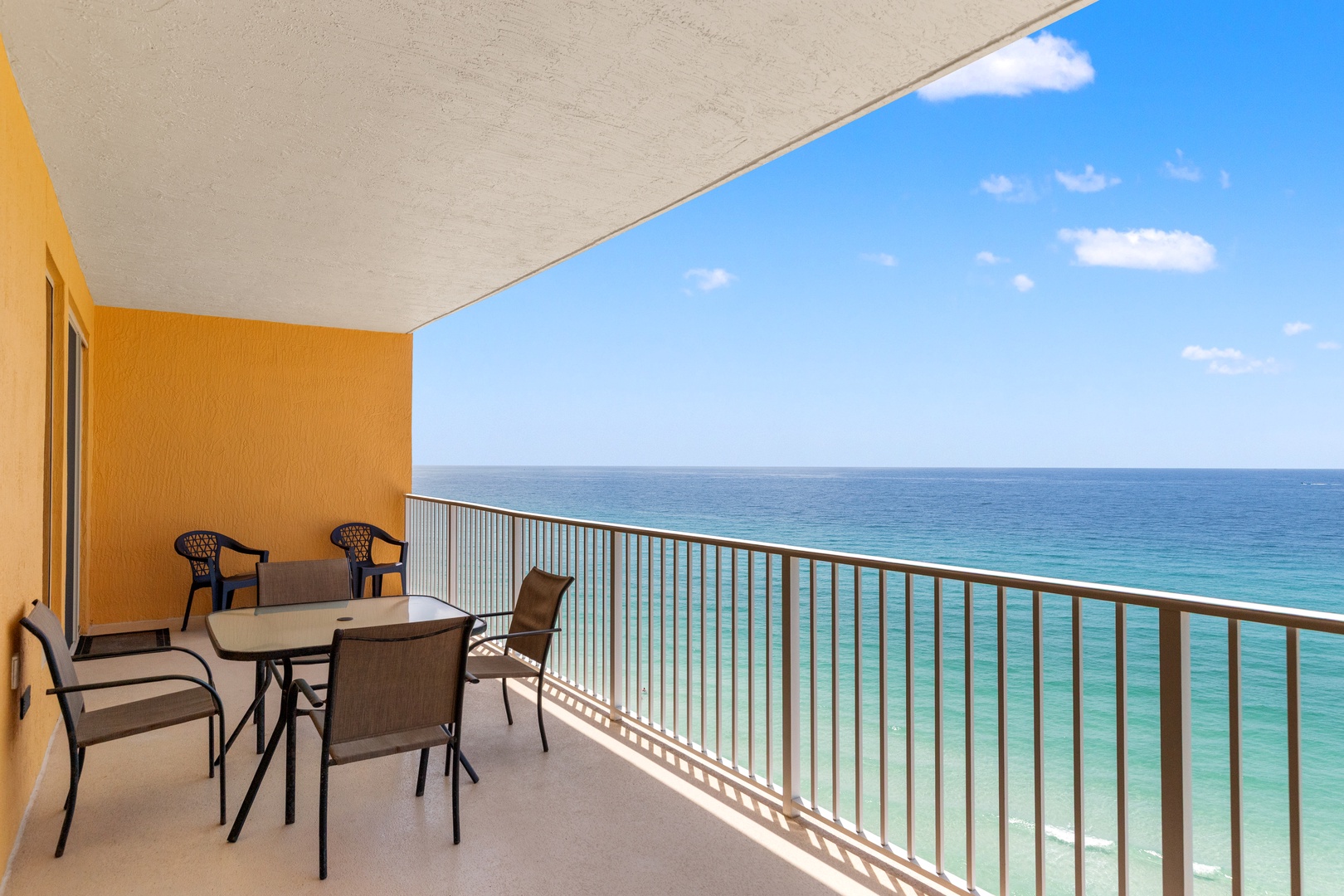 Enjoy your morning coffee while taking in endless ocean views from your private balcony, complete with comfortable seating for four.