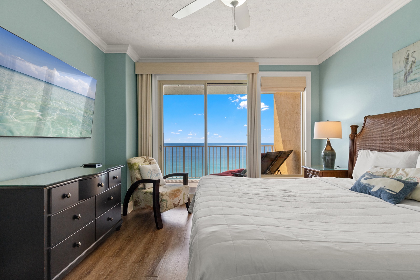 Wake up to stunning ocean views from your comfortable bedroom with direct balcony access and calming coastal colors.