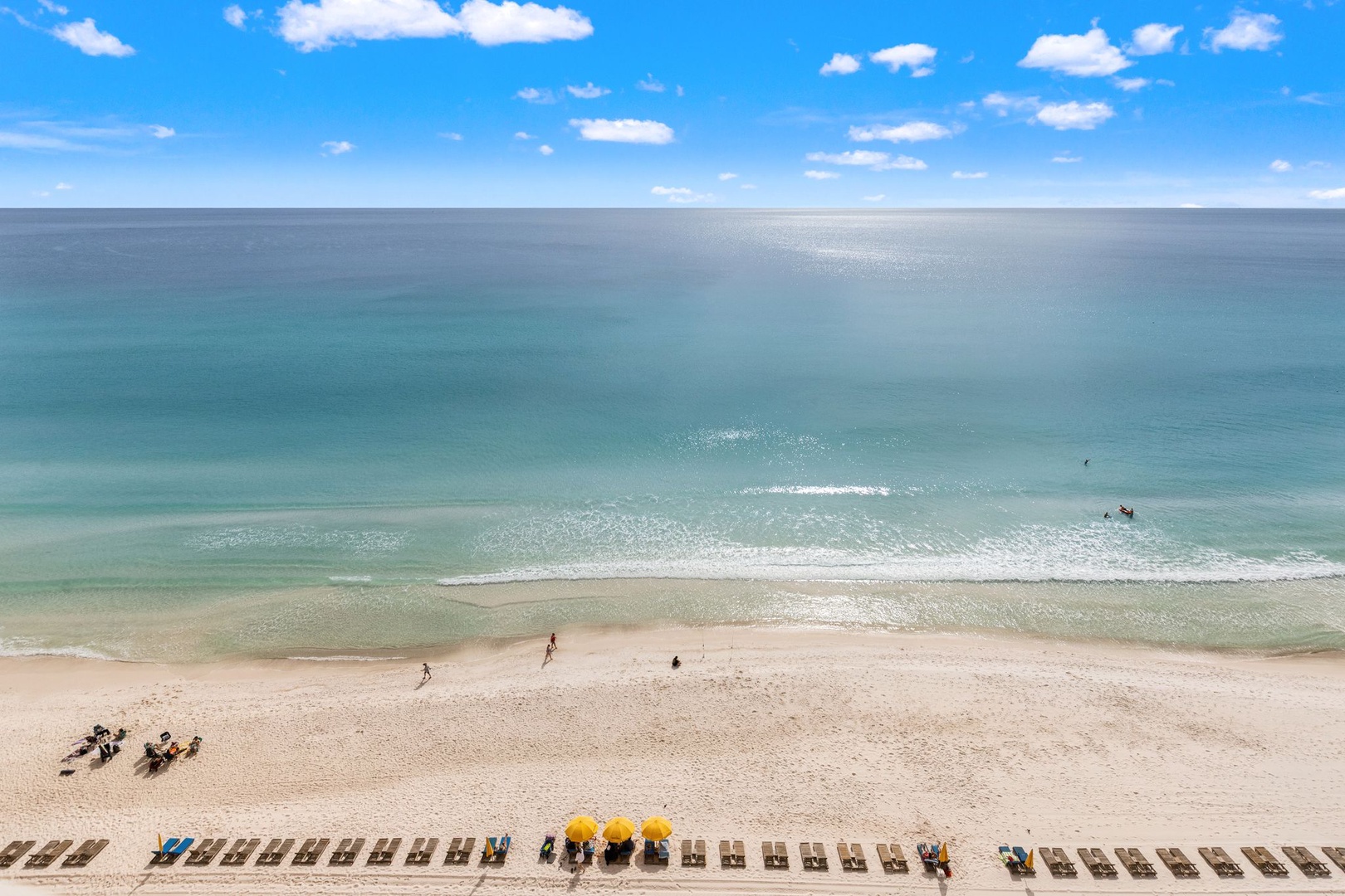 Stunning beachfront location with pristine white sand and crystal-clear turquoise waters stretching to the horizon.