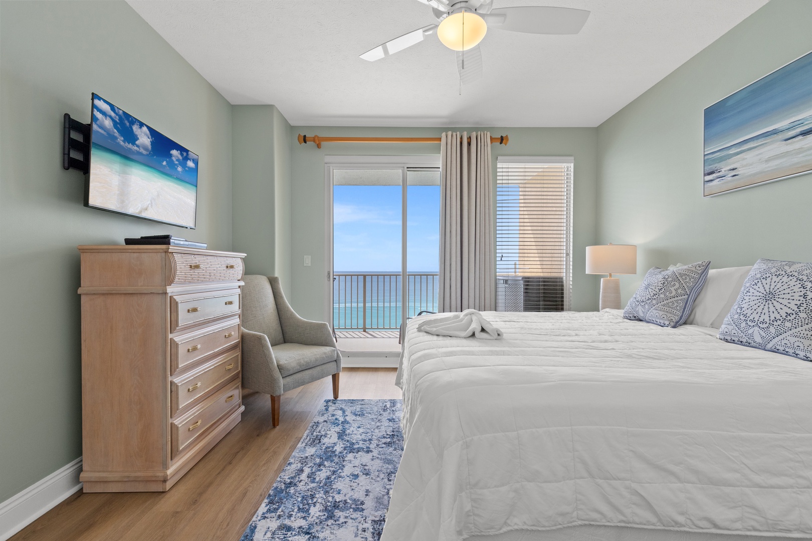 Wake up to stunning ocean views from your comfortable bed in this peaceful coastal bedroom retreat.
