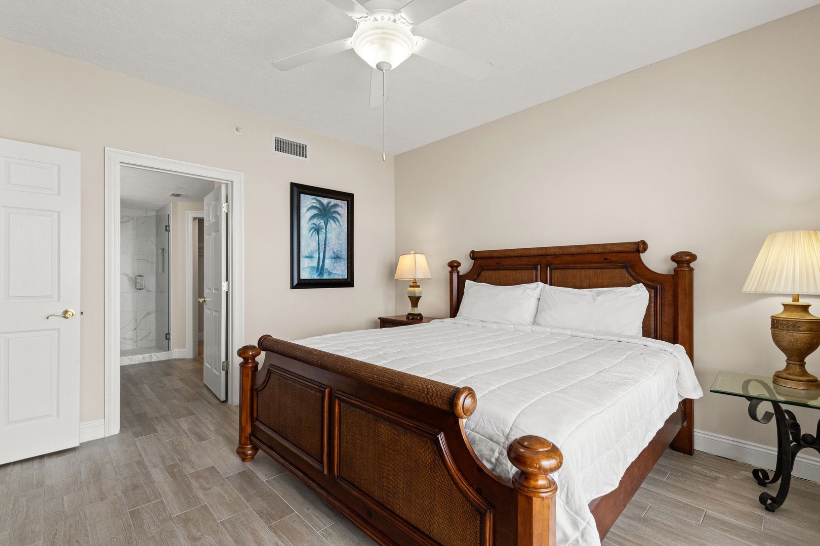 Drift off peacefully in your comfortable bedroom with tropical artwork and soft lighting creating the perfect retreat.