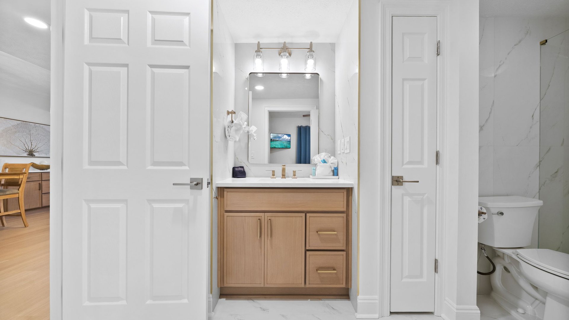 You'll love getting ready in this bright, modern bathroom with elegant vanity, perfect lighting, and thoughtful storage for all your essentials.