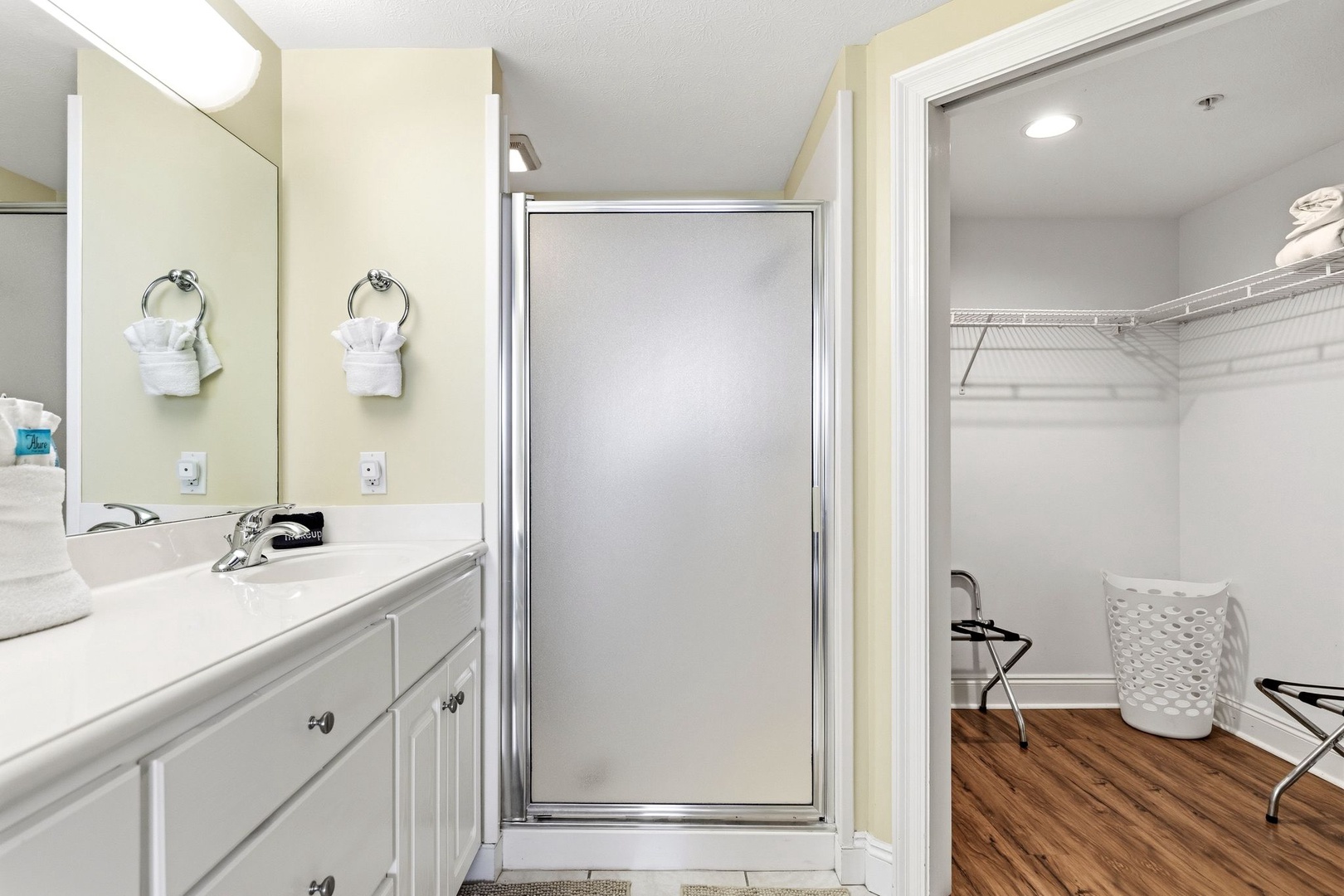 Your bathroom features a spacious glass shower, dual vanity sinks, and convenient adjoining closet space for all your belongings.
