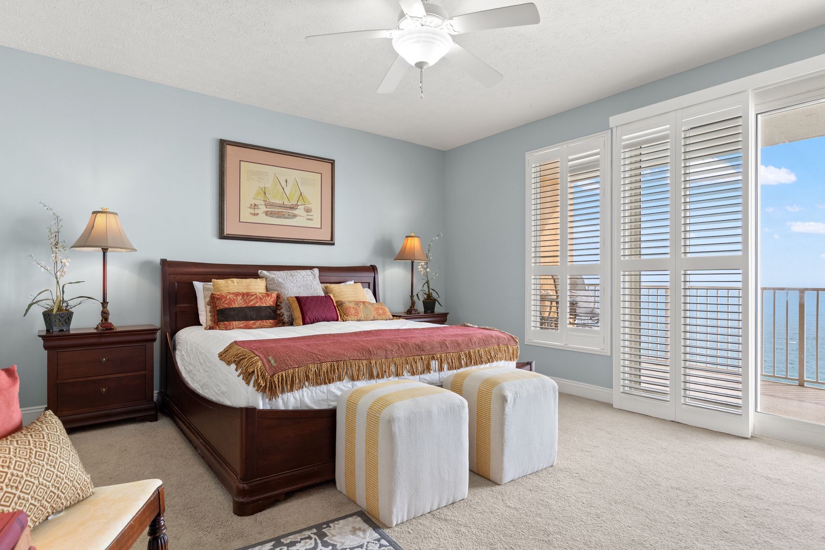 Unwind in your coastal bedroom, where serene sea breezes flow through shuttered doors and inviting linens promise a restful night.