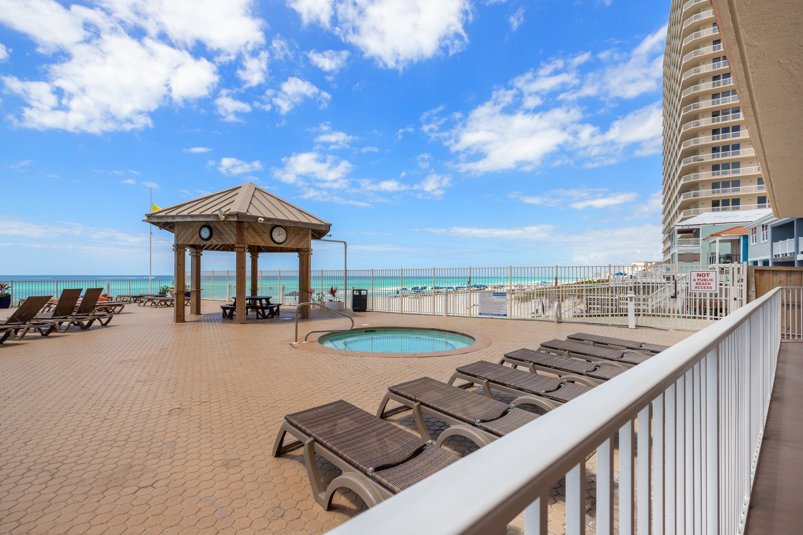 Beachfront pool deck with stunning ocean views, perfect for your morning coffee or evening relaxation under the covered pavilion.