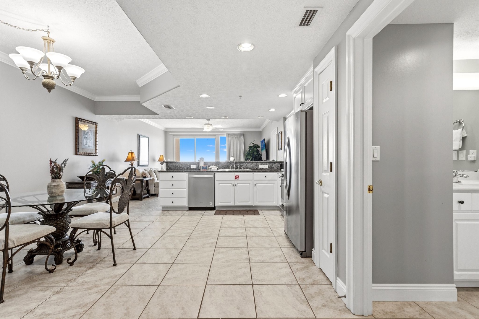 Your open-concept living space flows seamlessly from kitchen to living area, with stunning city views through floor-to-ceiling windows.