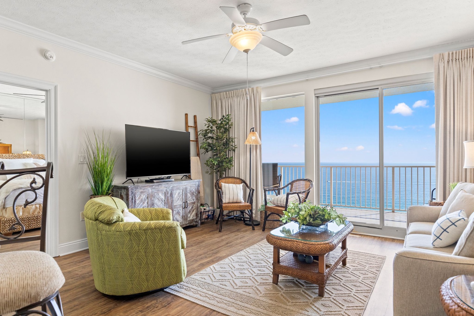 Picture yourself unwinding in this bright living space with stunning ocean views through the balcony doors, where coastal breezes and natural light create your perfect beachside retreat.