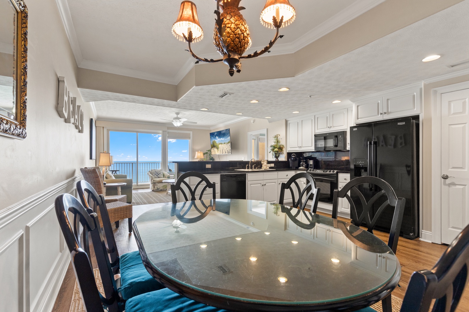 Gather around this elegant dining space where ocean views frame every meal, creating unforgettable moments with loved ones.