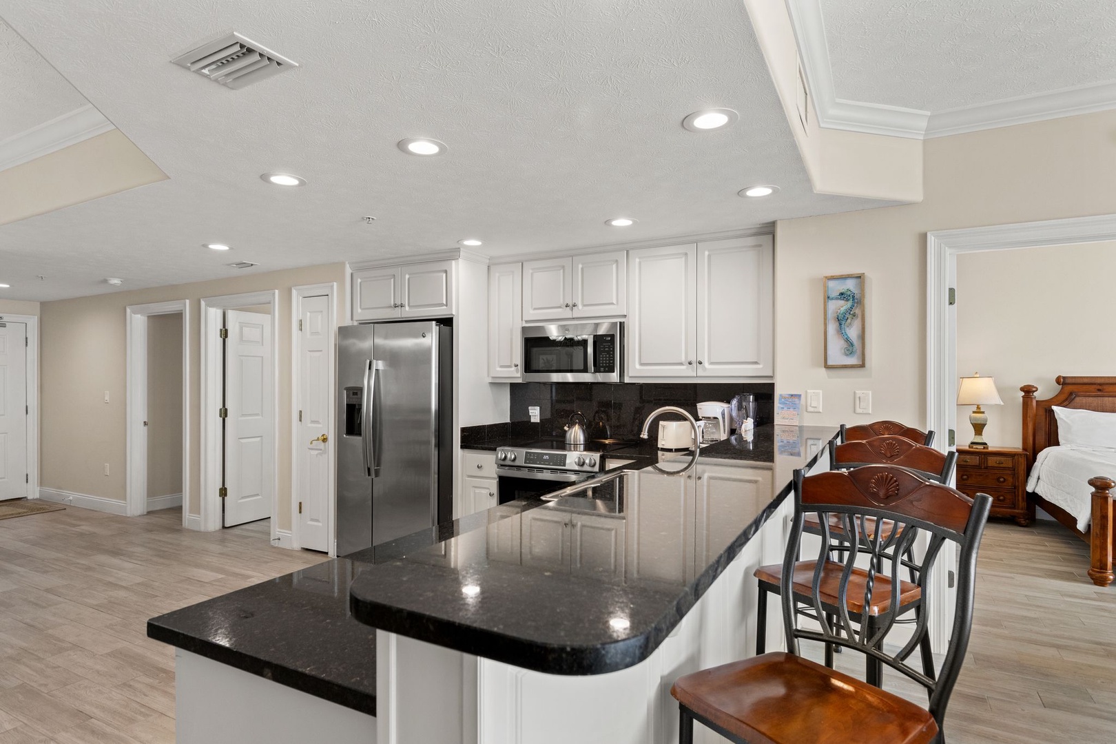 Prepare your favorite meals in this gleaming kitchen with granite counters, stainless appliances, and bar seating where you can sip coffee while breakfast cooks.