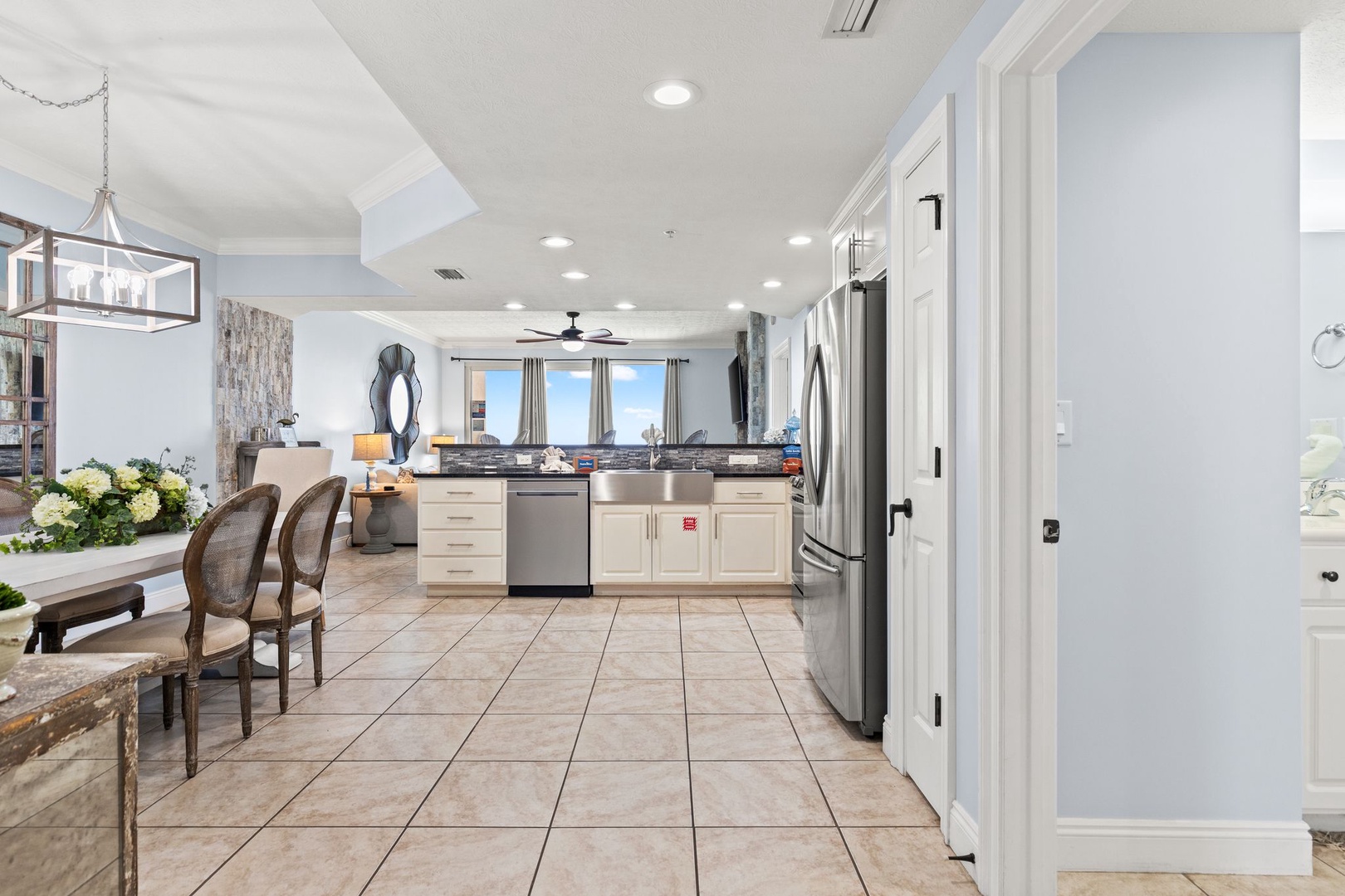 Step into your bright, open-plan living space where a fully-equipped kitchen flows seamlessly into a cozy dining and lounge area—perfect for gathering, cooking, and unwinding together after a day of adventure.