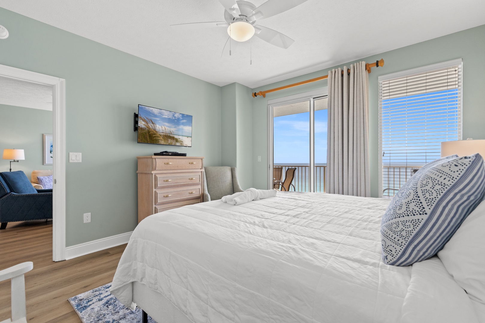 Wake up to ocean views in your serene bedroom with balcony access and soothing coastal decor.