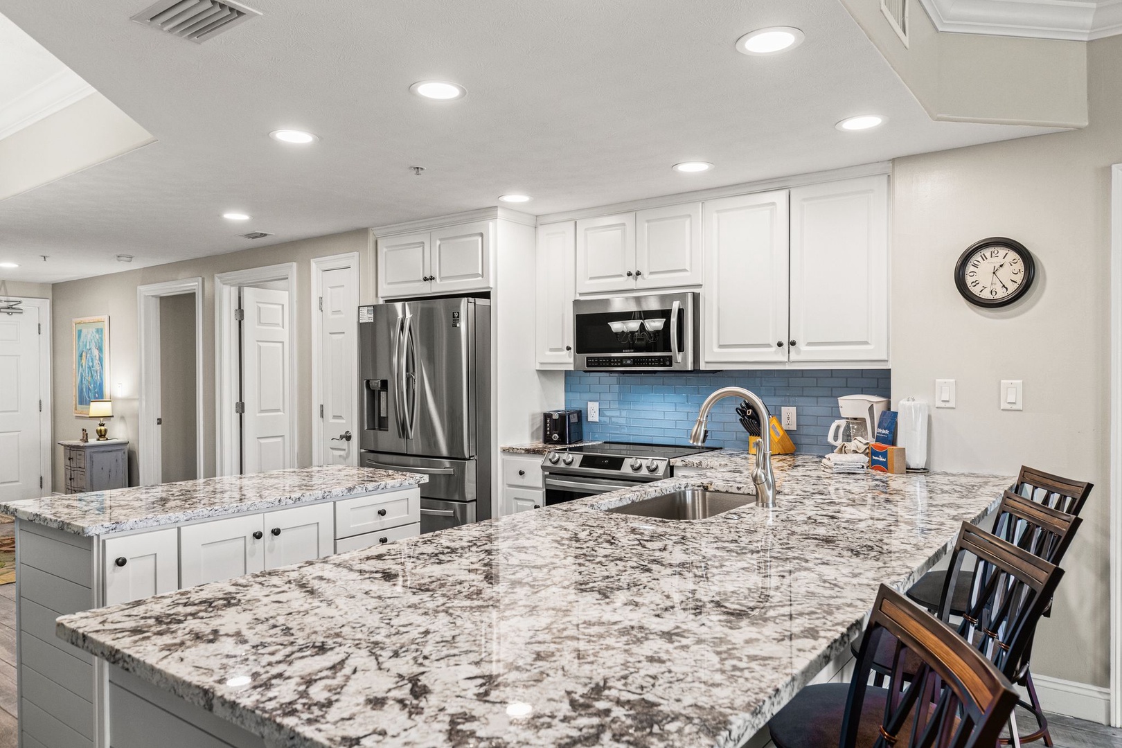This spacious chef's kitchen offers granite countertops, stainless steel appliances, and all the tools you need to create delicious meals during your stay.