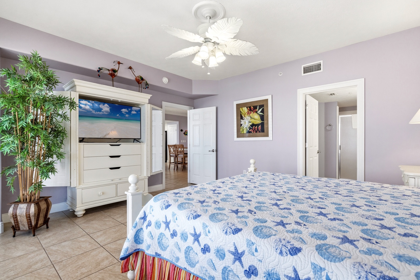 Drift off to sleep in your coastal sanctuary, where soothing lavender walls and ocean-themed bedding create the perfect seaside retreat for your vacation dreams.