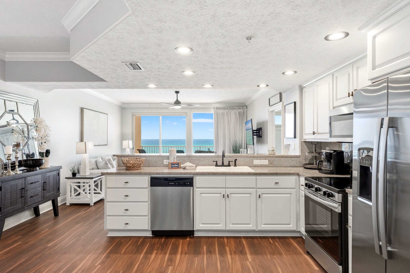 Your gourmet kitchen opens to stunning ocean views, featuring granite counters, stainless steel appliances, and everything you need for memorable meals.