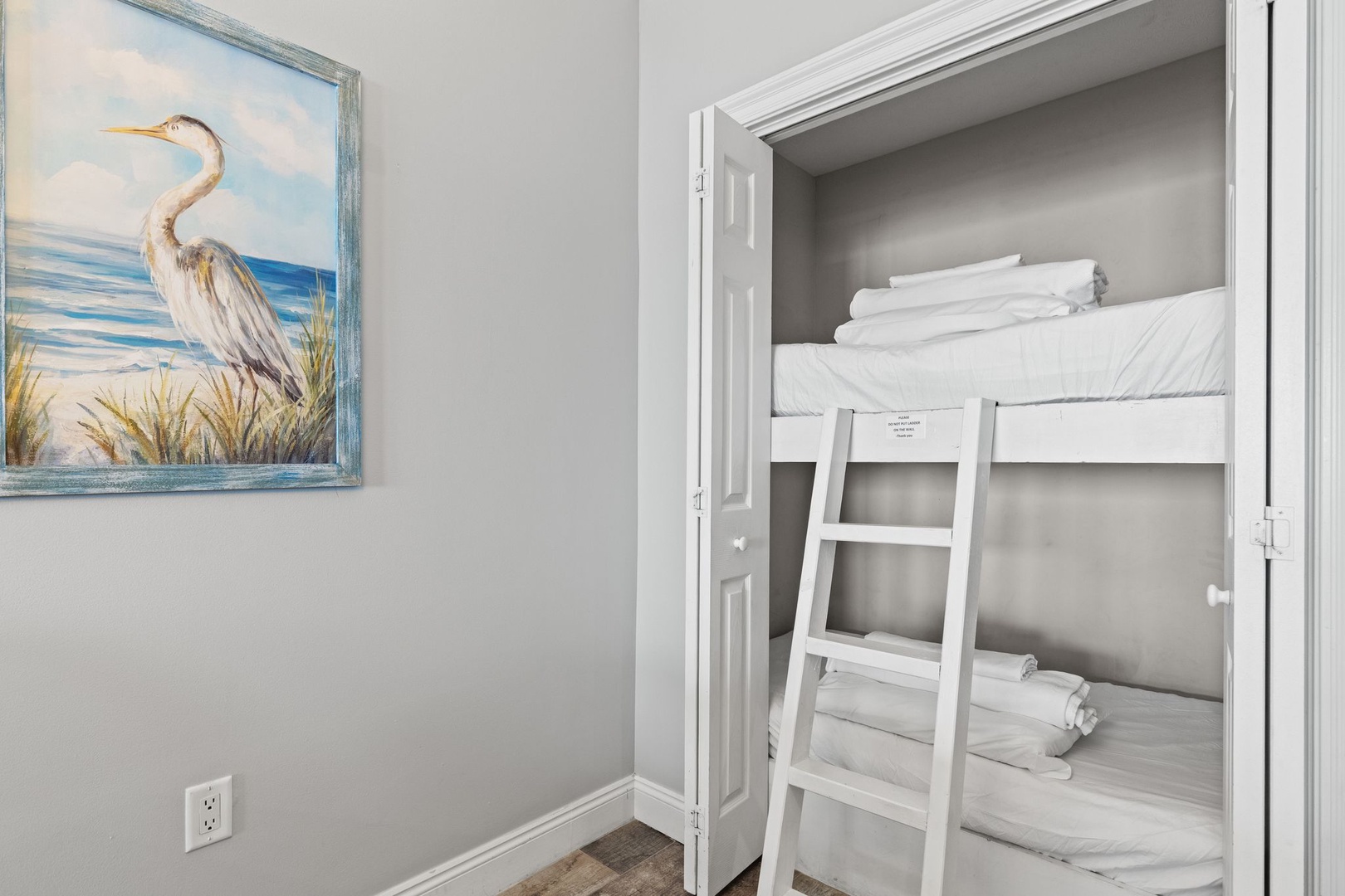 Your coastal-themed bunk nook offers cozy sleeping quarters with fresh linens and beachy artwork—perfect for the kids or extra guests to settle in comfortably.