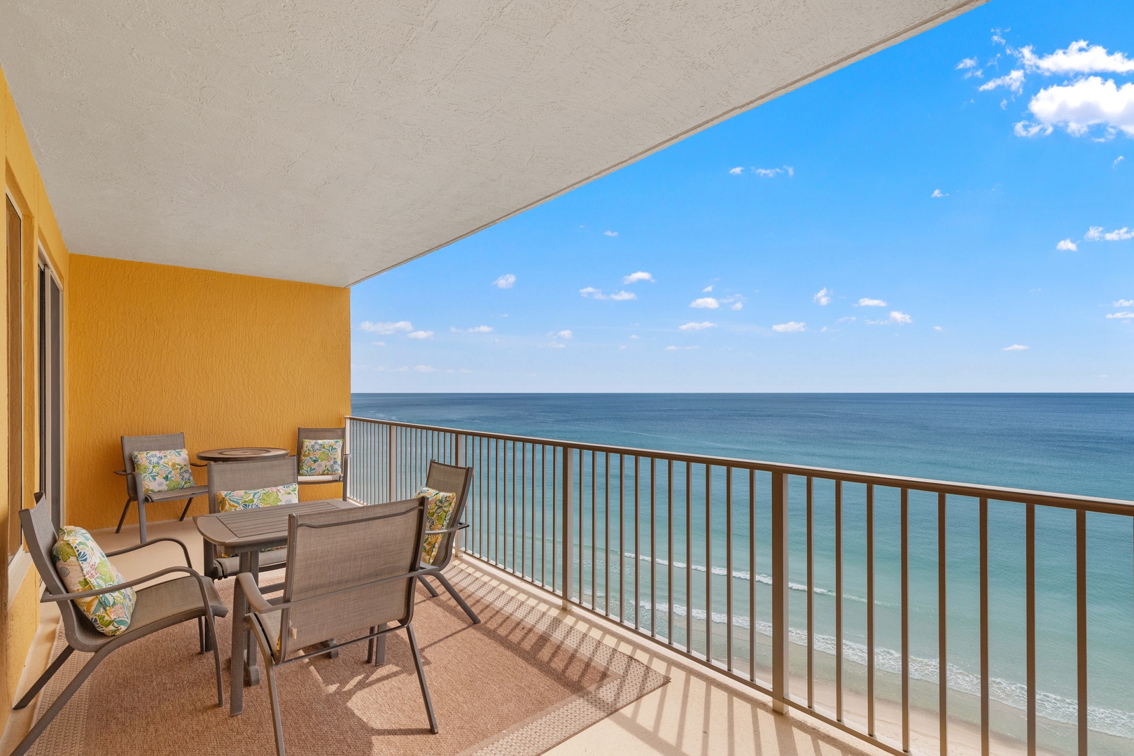 Sip your morning coffee on this oceanfront balcony where endless turquoise waters and gentle waves create your perfect backdrop for relaxation.