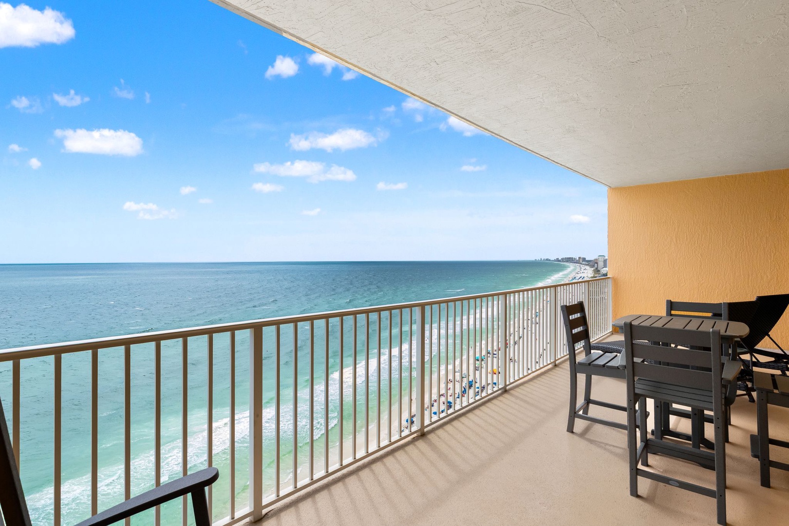 The property's beachfront balcony offers sweeping views of the turquoise Gulf waters and pristine sandy shoreline below.