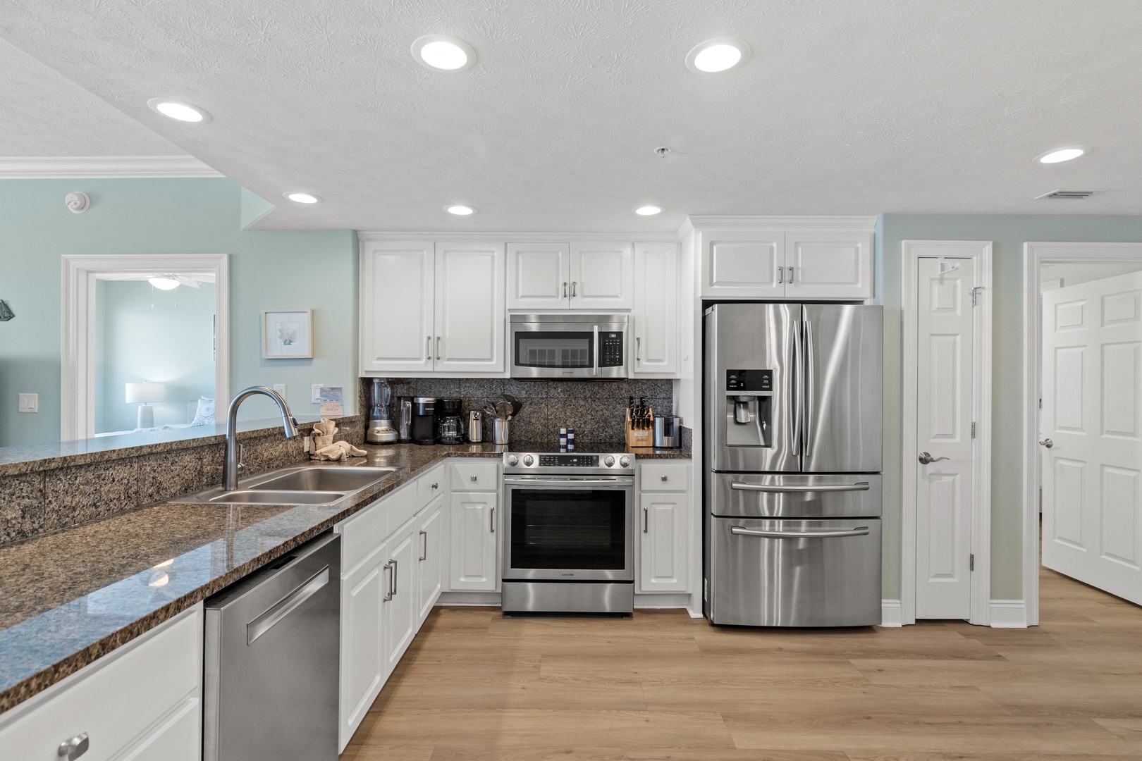 Your spacious kitchen features granite countertops, stainless steel appliances, and everything you need to create memorable meals during your stay.