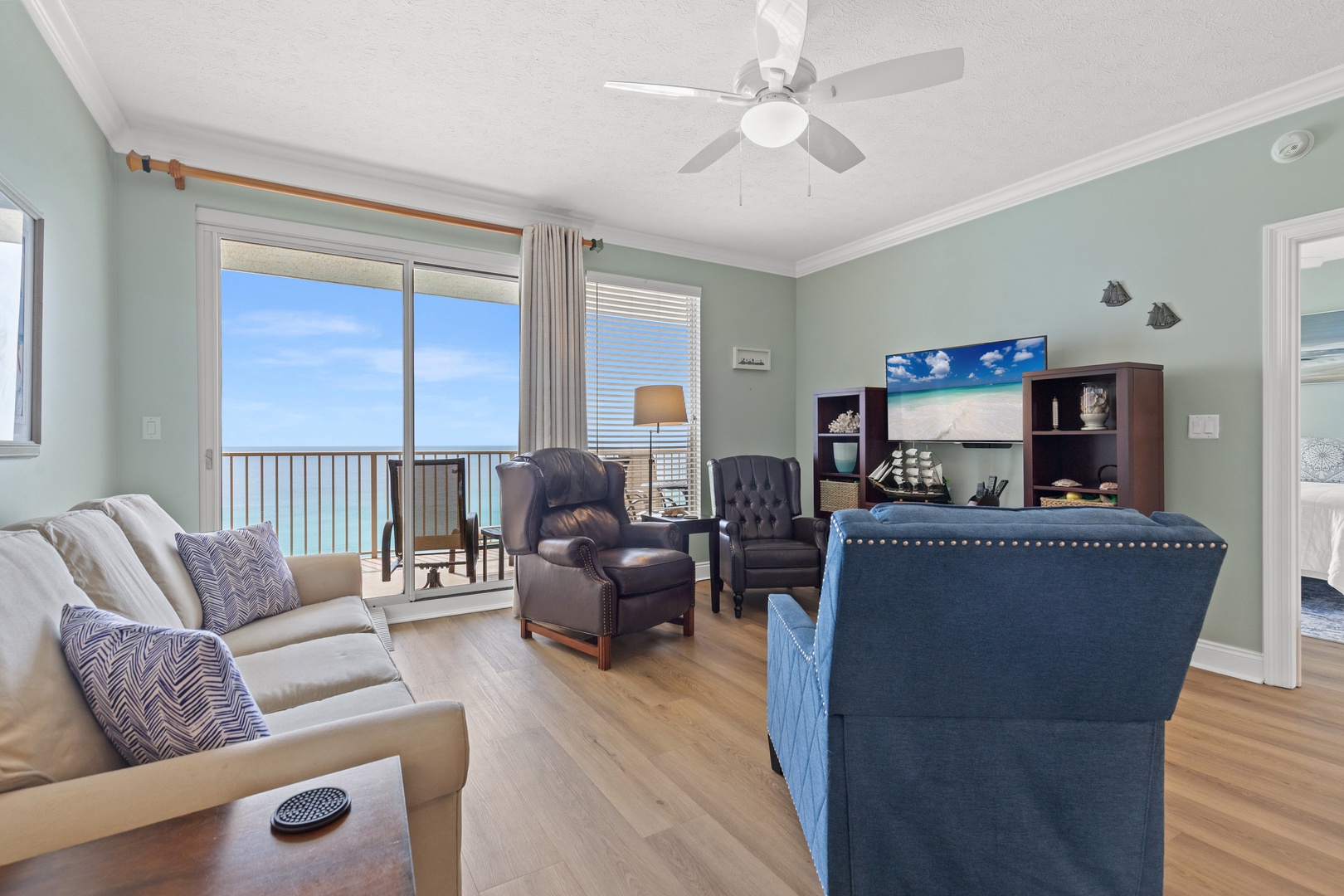 Sink into plush seating with ocean views through your private balcony doors—your perfect coastal retreat awaits.