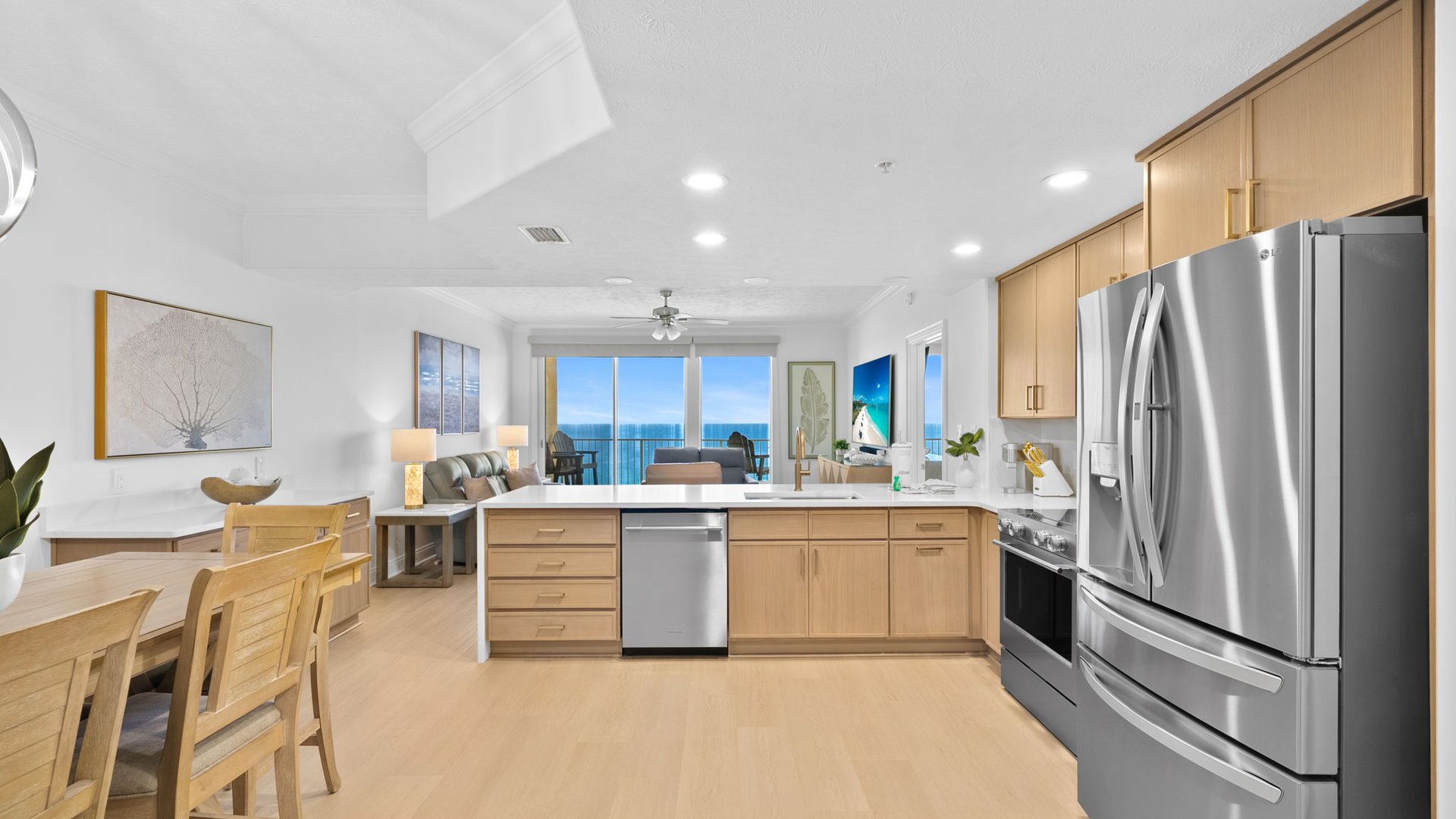 Your modern kitchen opens to the living area with stunning ocean views through floor-to-ceiling windows.