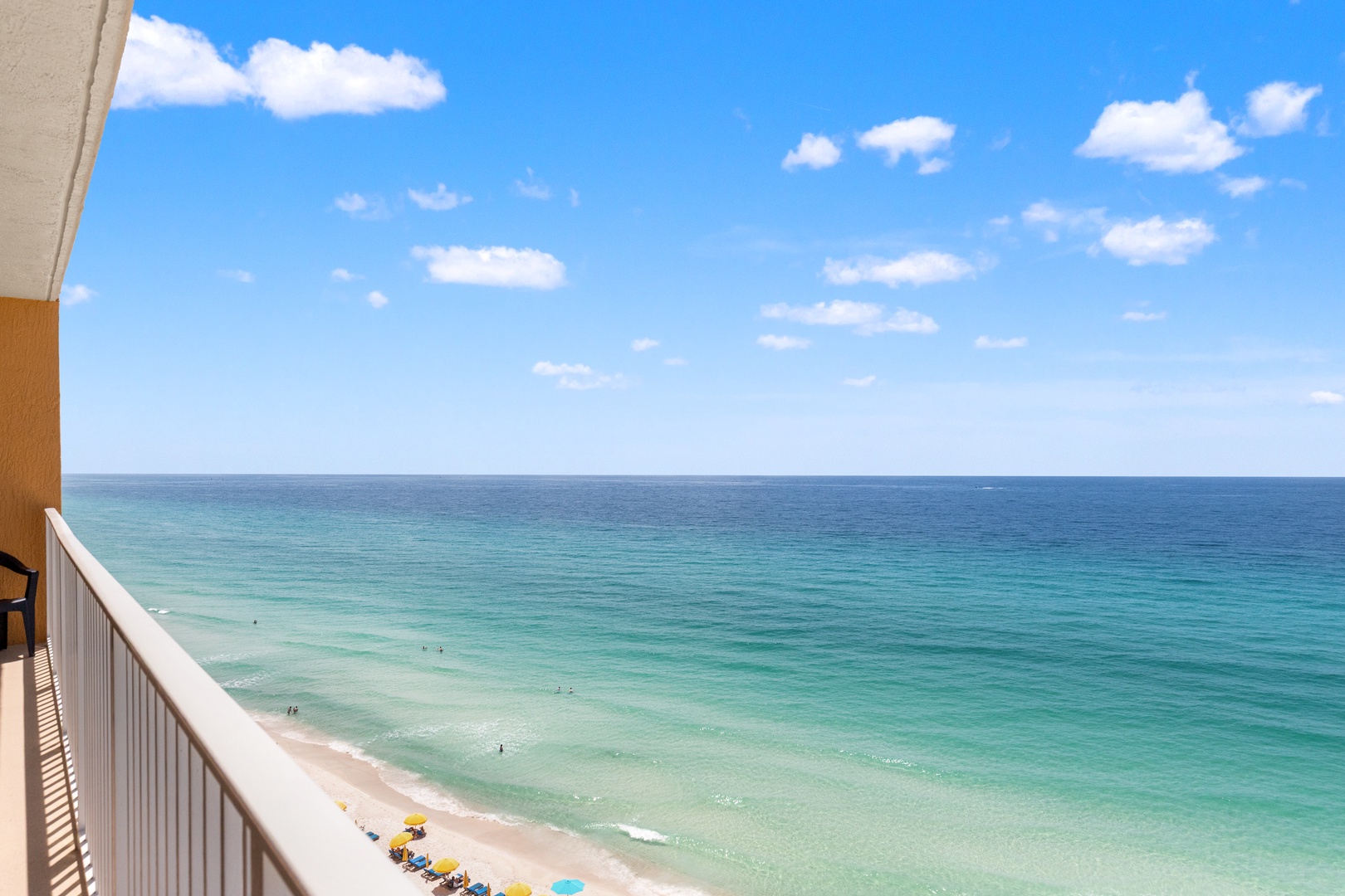 Breathtaking panoramic view of turquoise waters and pristine sandy shores, where the horizon meets endless blue skies—a perfect backdrop for your coastal escape.