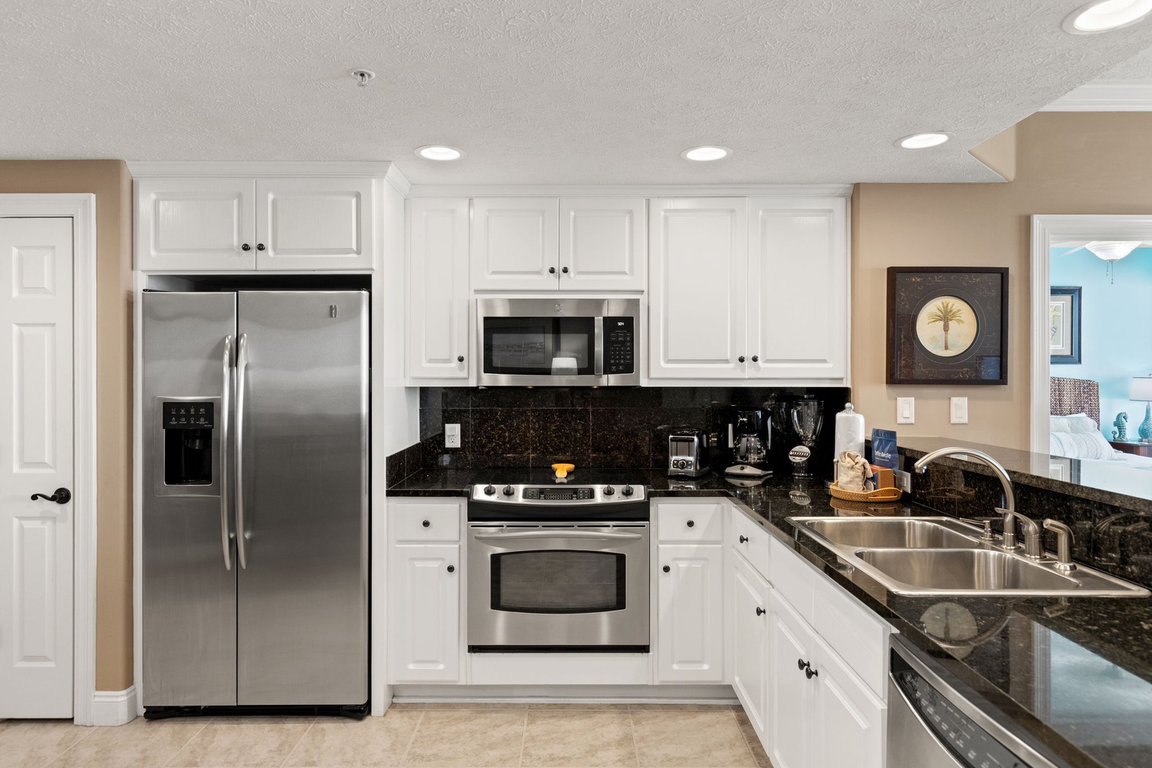 You'll find everything you need in this fully equipped kitchen with granite counters, stainless appliances, and plenty of cabinet space for your stay.