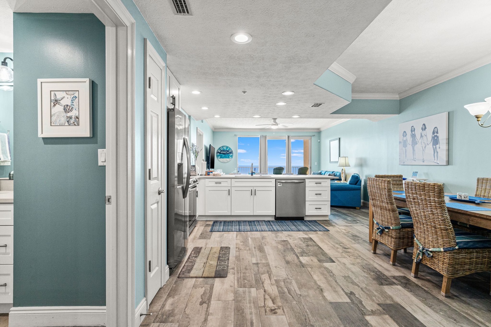 Open-concept living with sea breezes at your fingertips. Rustic floors warm the space while bright views and coastal accents invite you to relax and unwind.