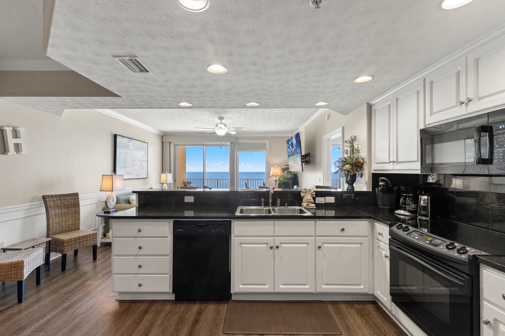 Your fully equipped kitchen offers stunning ocean views while you prepare meals, with modern appliances and granite countertops creating the perfect culinary retreat.