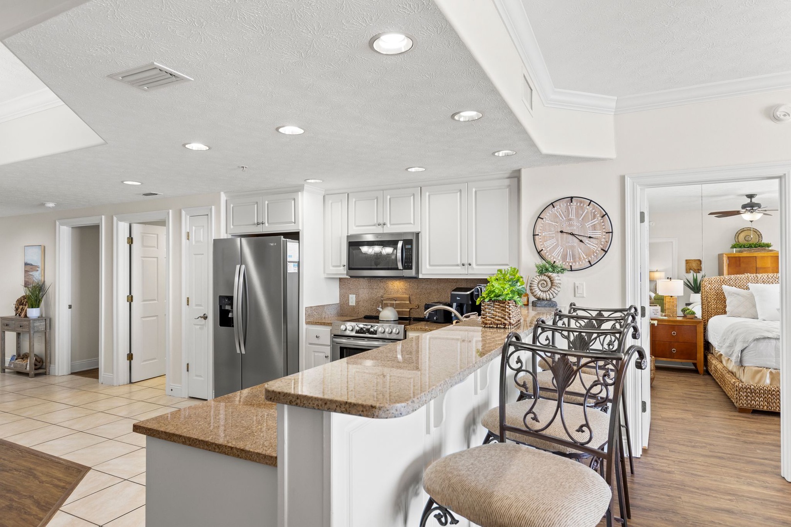 Your spacious kitchen invites you to cook and gather, with granite counters, stainless appliances, and an island for easy meal prep and conversation.