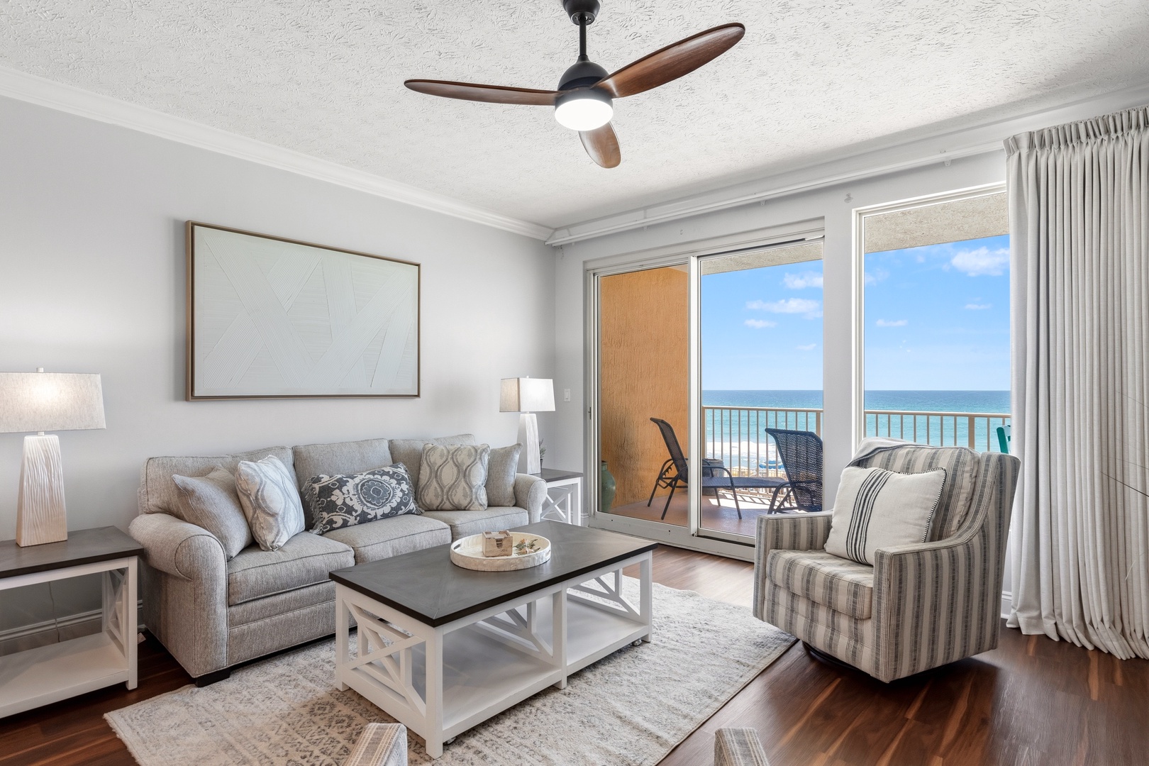 Unwind in this elegant living room where ocean breezes flow through sliding doors to your private balcony overlooking turquoise waters.