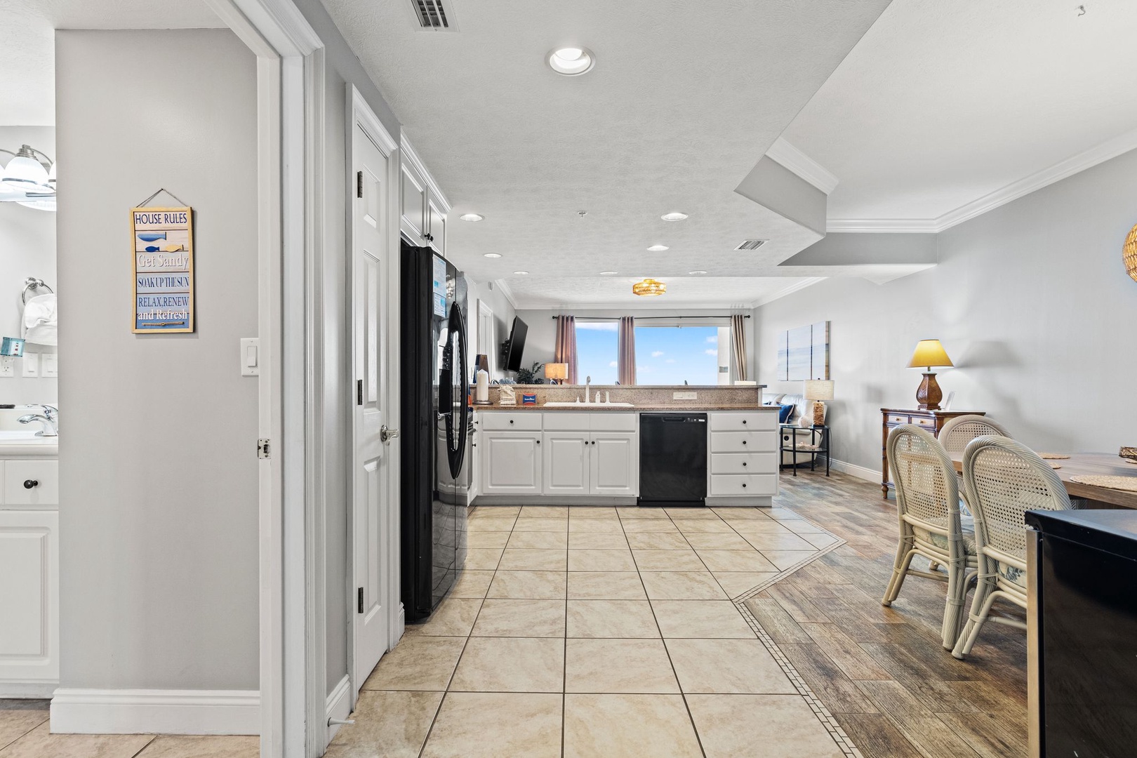 Your spacious open-concept kitchen and dining area blends modern convenience with coastal charm, inviting you to cook and gather in bright, welcoming comfort.