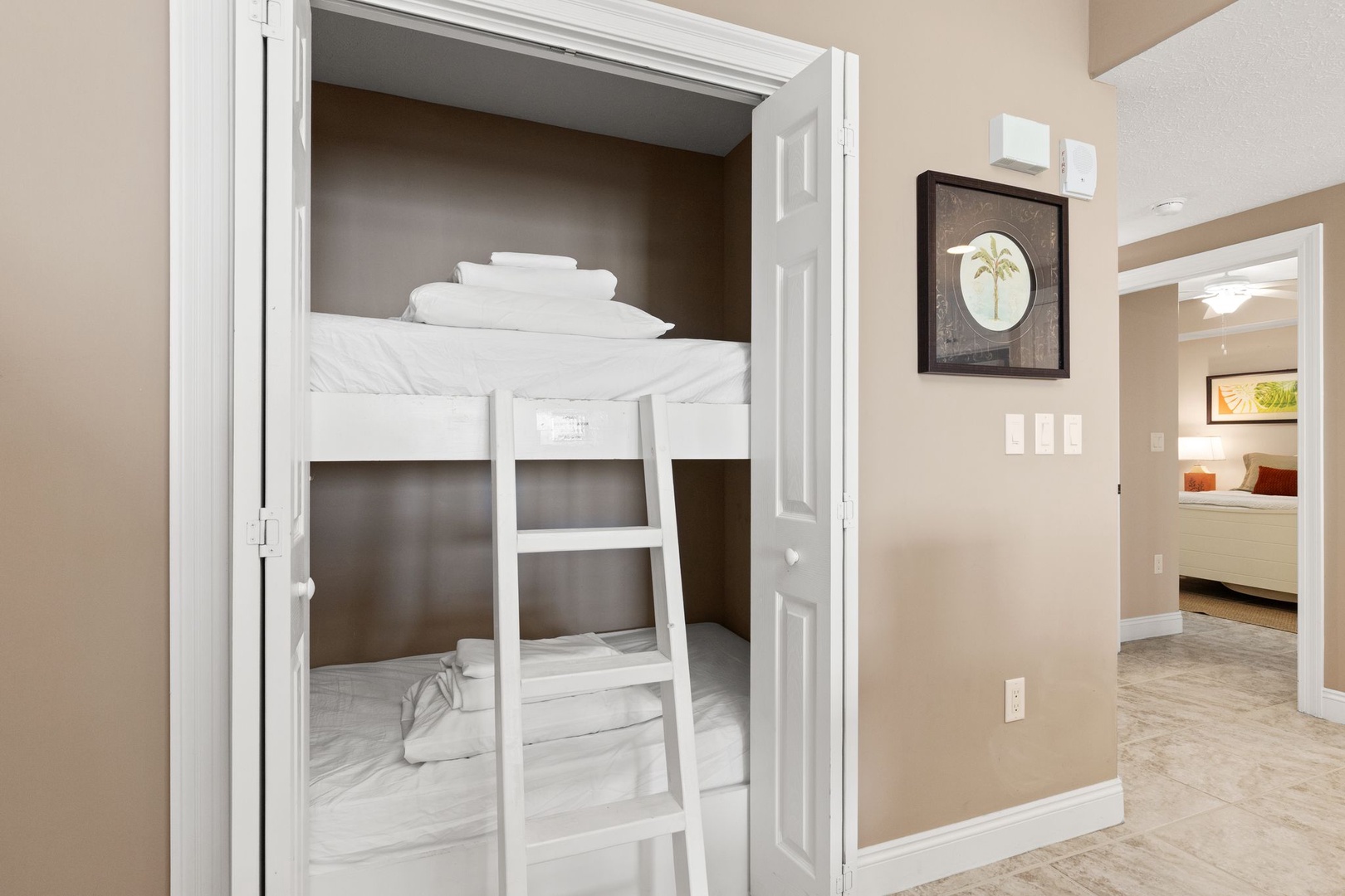 Step into your built-in bunk nook, where fresh linens and clever space-saving design create a cozy retreat perfect for kids or extra guests.