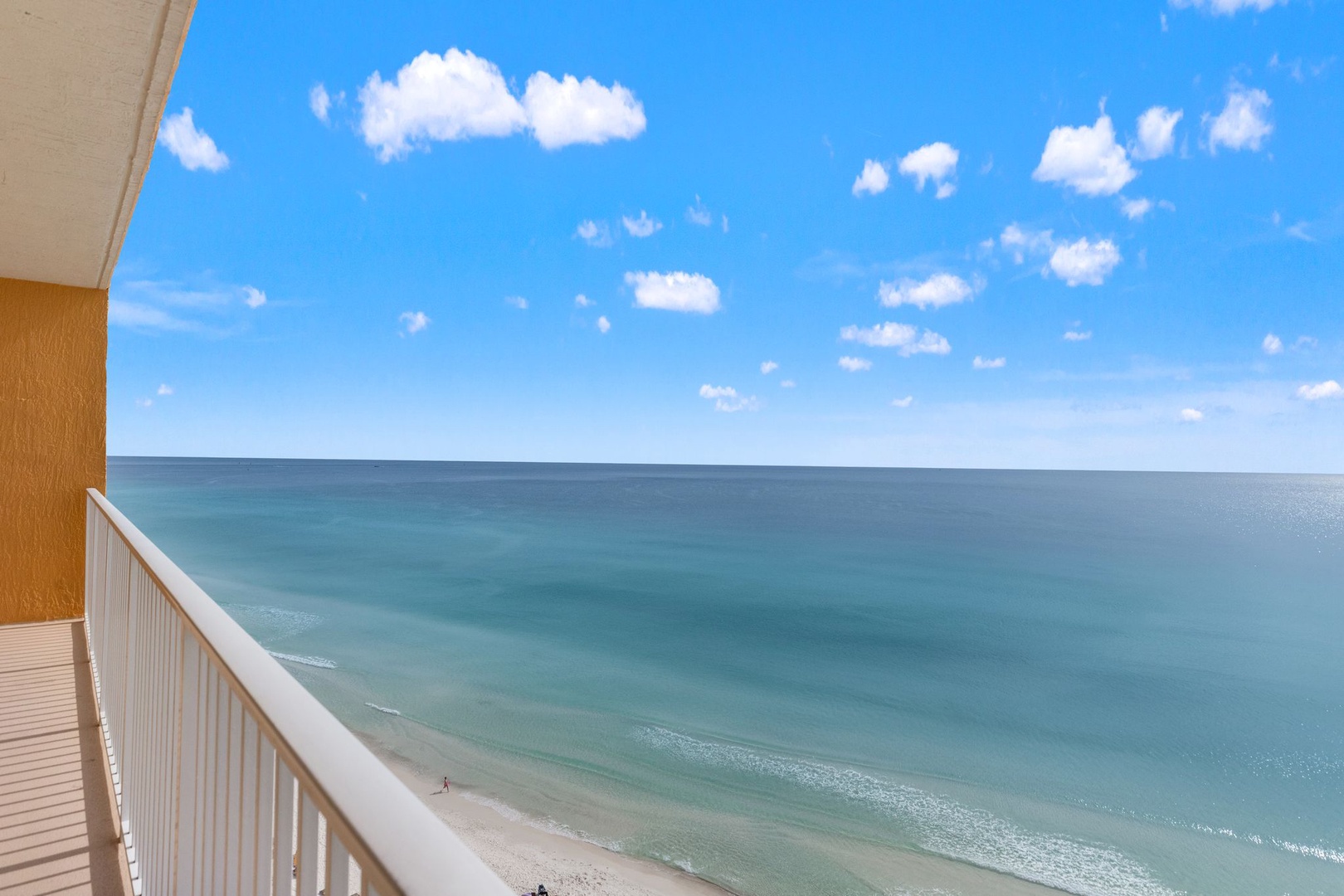 Stunning ocean views stretch endlessly from your private balcony, where turquoise waters meet pristine sandy shores below.